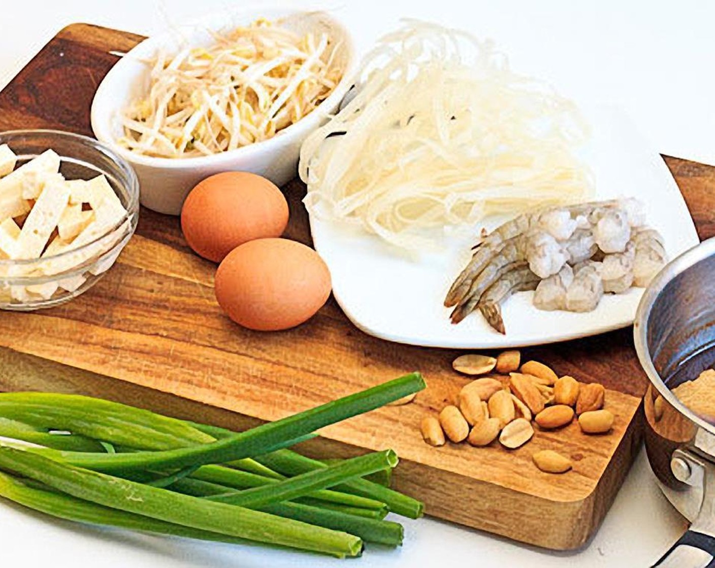 step 3 Rinse Bean Sprouts (2 cups) and Scallions (2 bunches), dice the Garlic (4 cloves), cut the Lime (1) into quarters and crush the Dry Roasted Peanuts (1/3 cup).