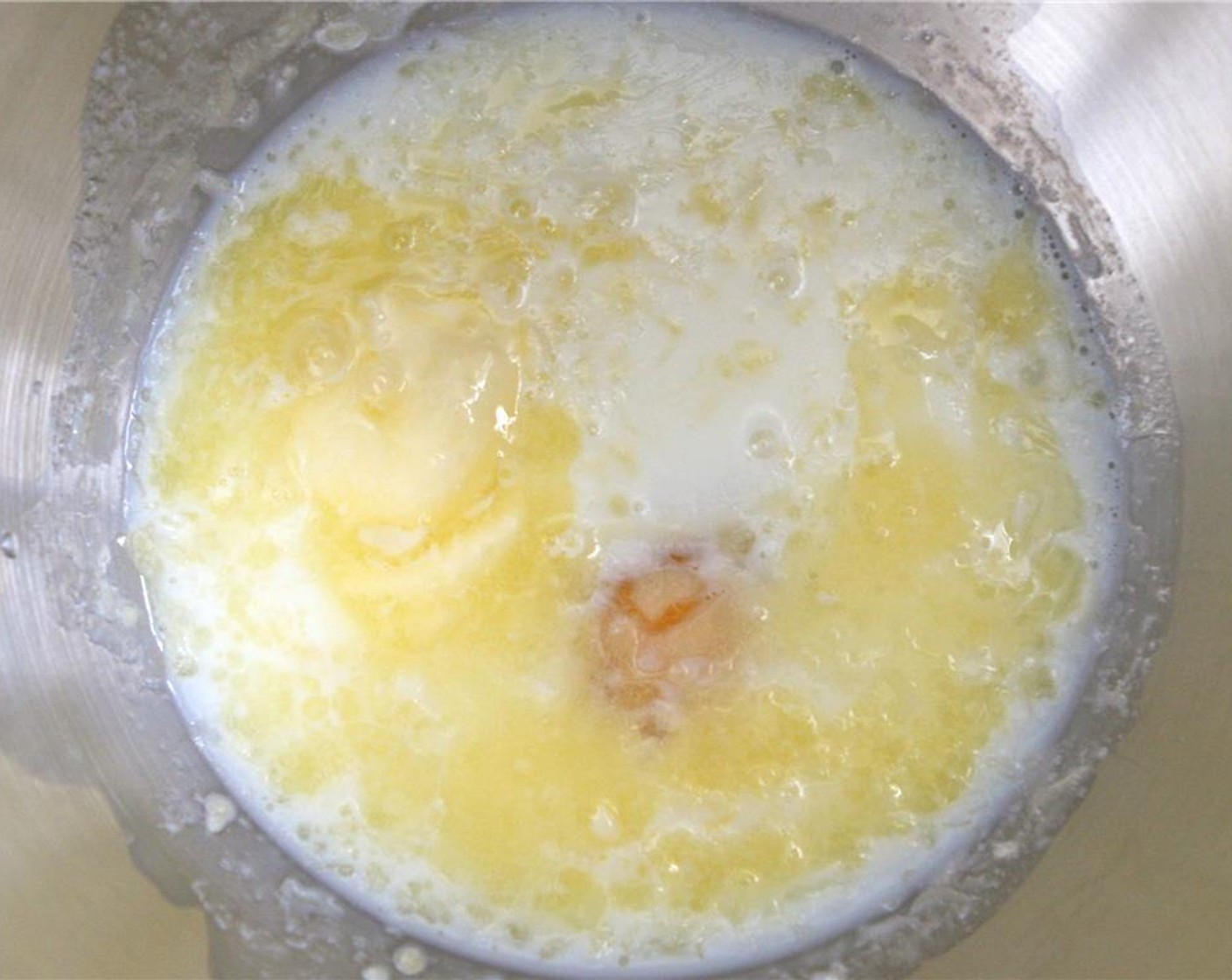 step 3 In a large bowl, combine Milk (1 Tbsp), Eggland's Best Classic Egg (1), Butter (2 Tbsp), and Almond Extract (1/2 tsp). Using a mixer or spoon, mix wet ingredients until creamy.