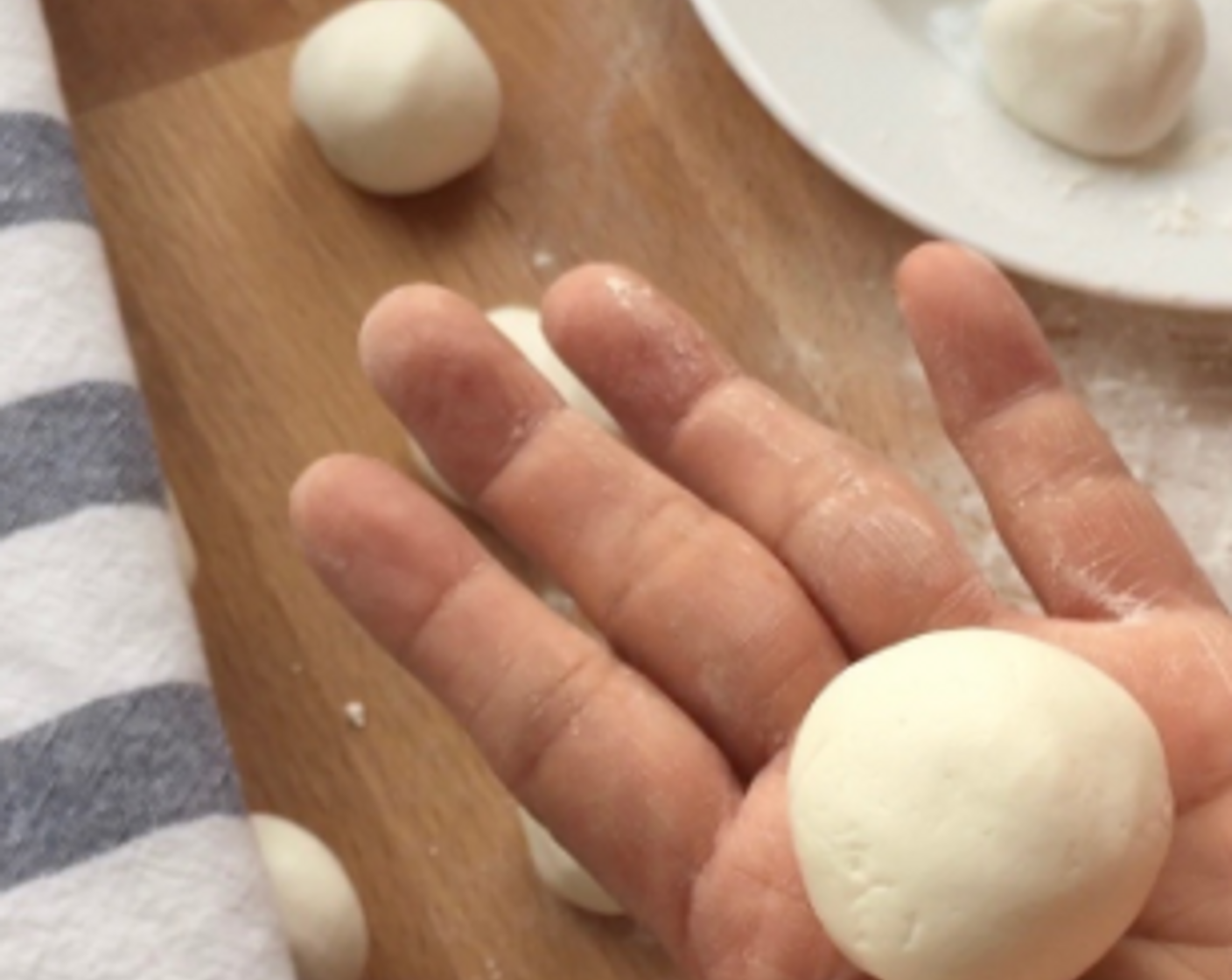 step 22 Wrap the dough around the filling and roll into a smooth ball. Repeat the same with the rest of the dough balls. And we have made glutinous rice balls with black sesame filling!