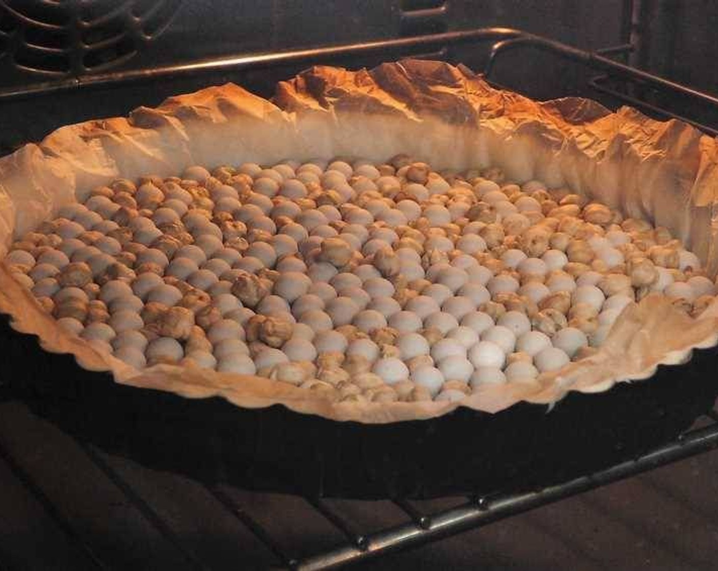 step 3 Next, place baking paper over the pastry and fill the pie with baking weights. Place into the oven and bake for 15 minutes.