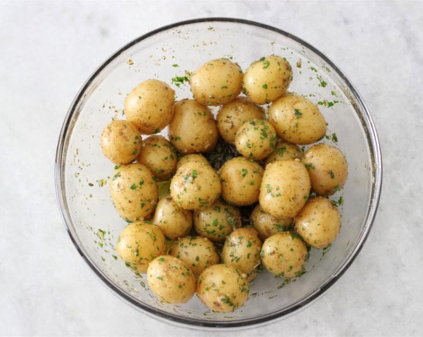 step 5 Drain potatoes. Add the drained, still-hot potatoes to the bowl and mix it all to combine, so that the potatoes are completely coated in the garlic, herb and seasoning mixture. After seasoning the cooked potatoes, cool them completely and store in a covered container in the refrigerator until you are ready to grill the kebabs.