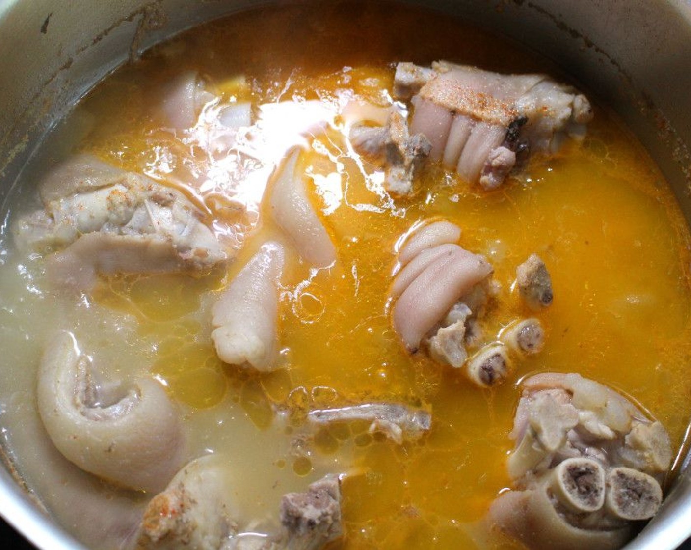 step 1 Simmer Pig's Trotters (5 lb) in Water (12 cups) with Salt (to taste) until tender.