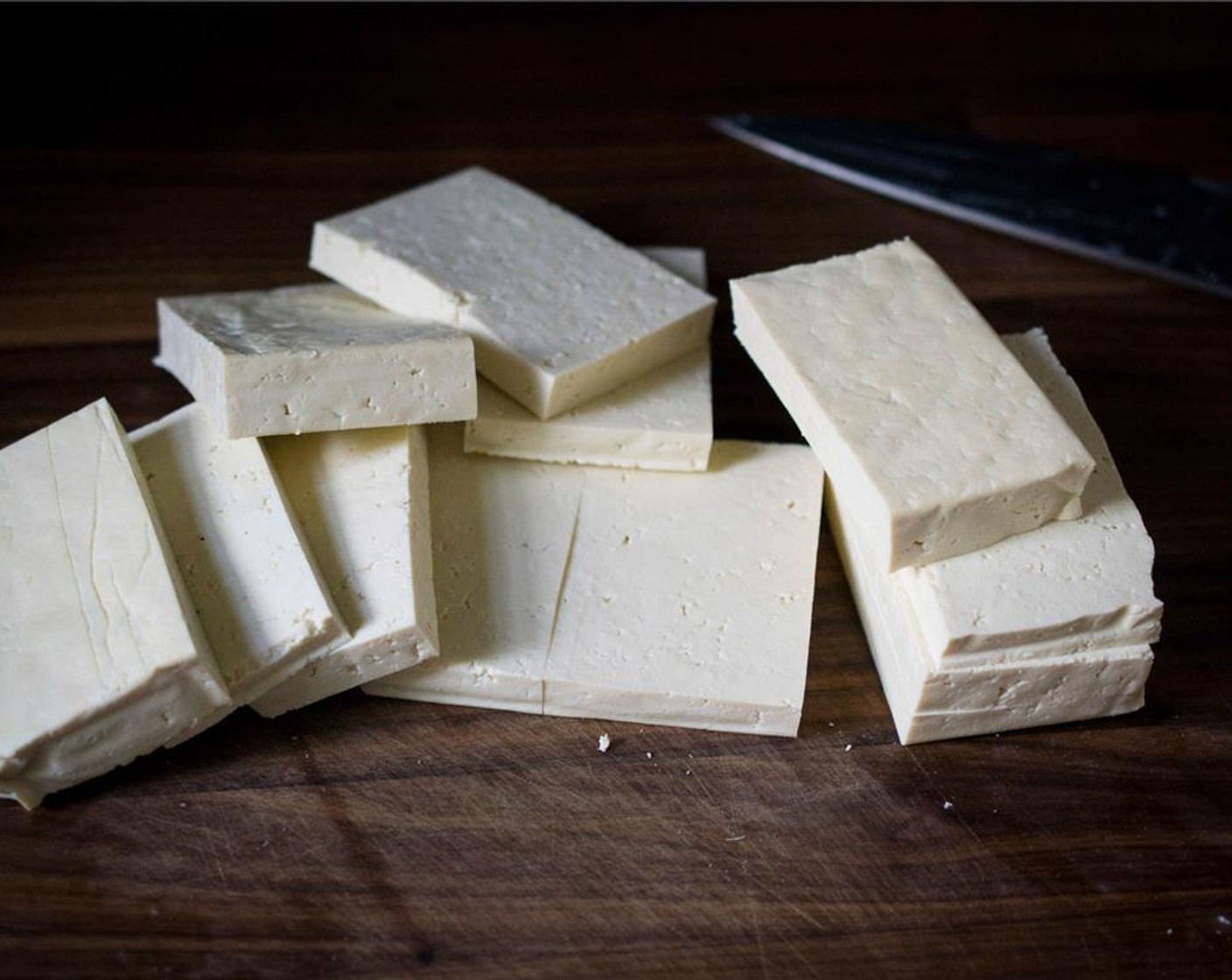 step 1 Using a clean tea towel, firmly press the block of Extra Firm Tofu (1.3 lb) to remove the excess moisture. Cut the tofu into 1/2-inch slices. Then cut in half (around 2-3 inches across).
