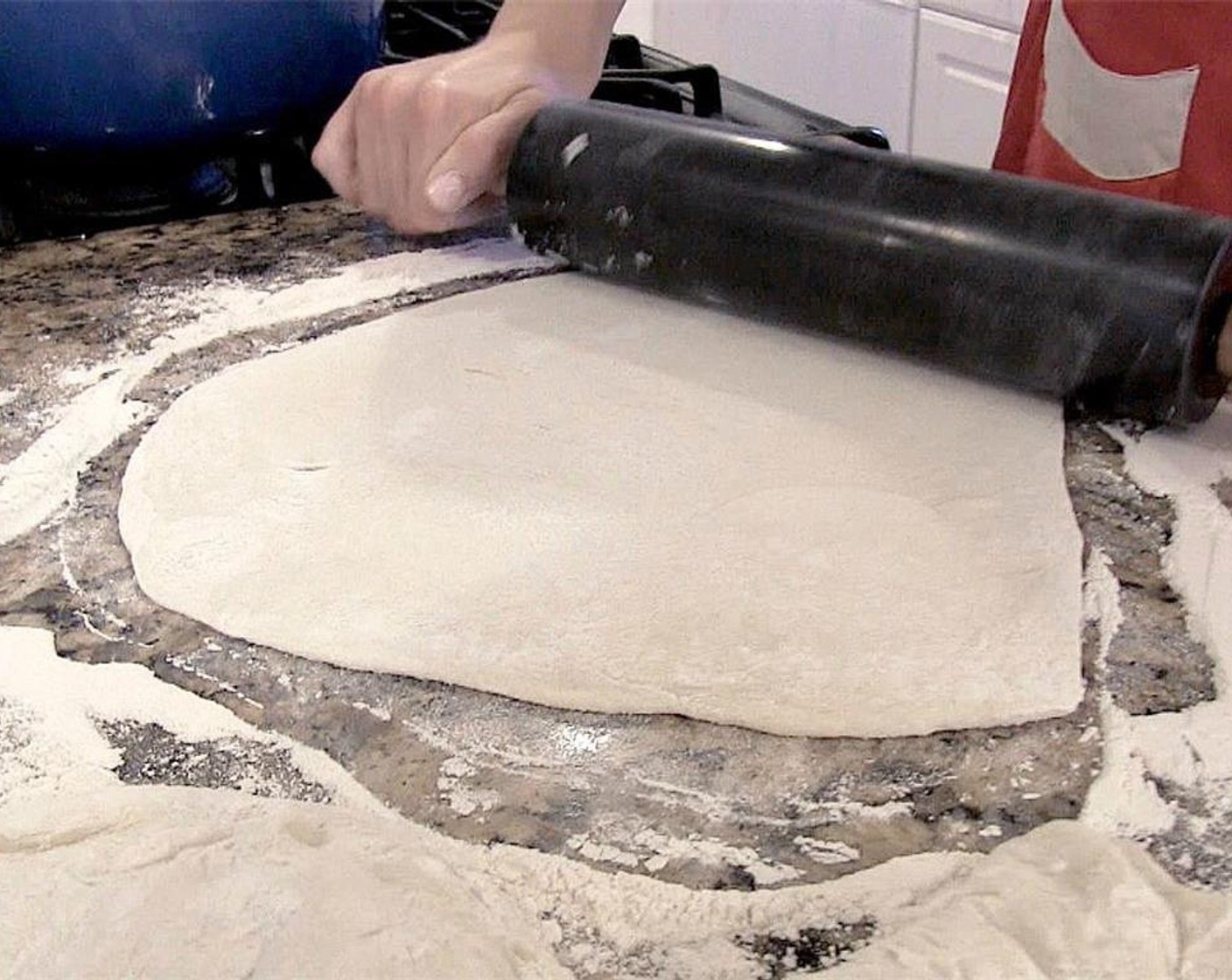 step 9 Divide Fresh Pizza Dough (1 lb) in half. Roll out the first half on a counter dusted in All-Purpose Flour (1/2 cup).