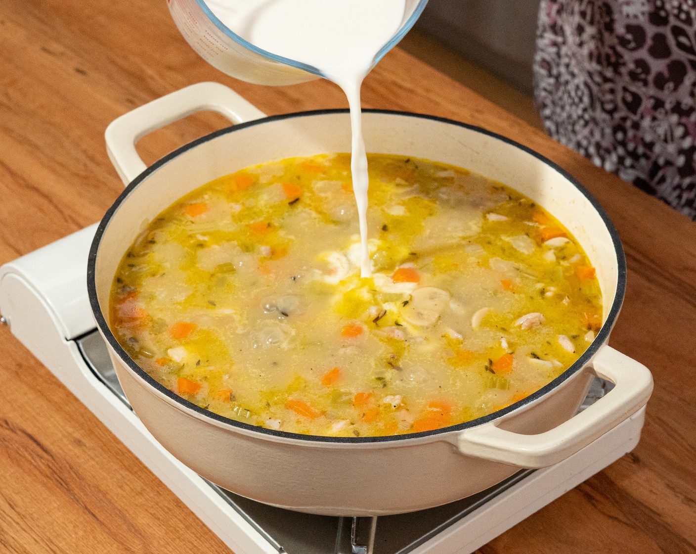 step 8 Once the wild rice pieces have burst out of their shells, add in the Milk (2 cups) slowly while stirring. Continue to cook for about 5 minutes, or until the soup has reached your desired level of thickness.