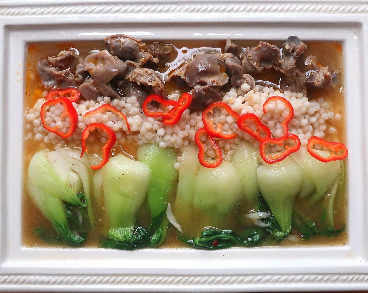 step 8 Serve bok choy and gizzards. Add Israeli Couscous (to taste), add the broth and a few Red Chili Peppers (to taste). Enjoy!