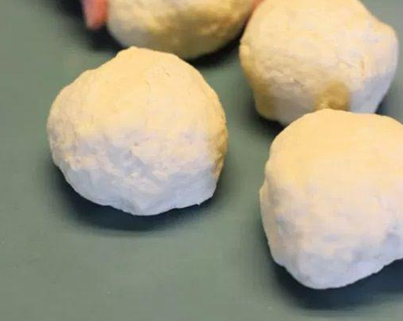 step 4 Divide dough into four equal balls.
