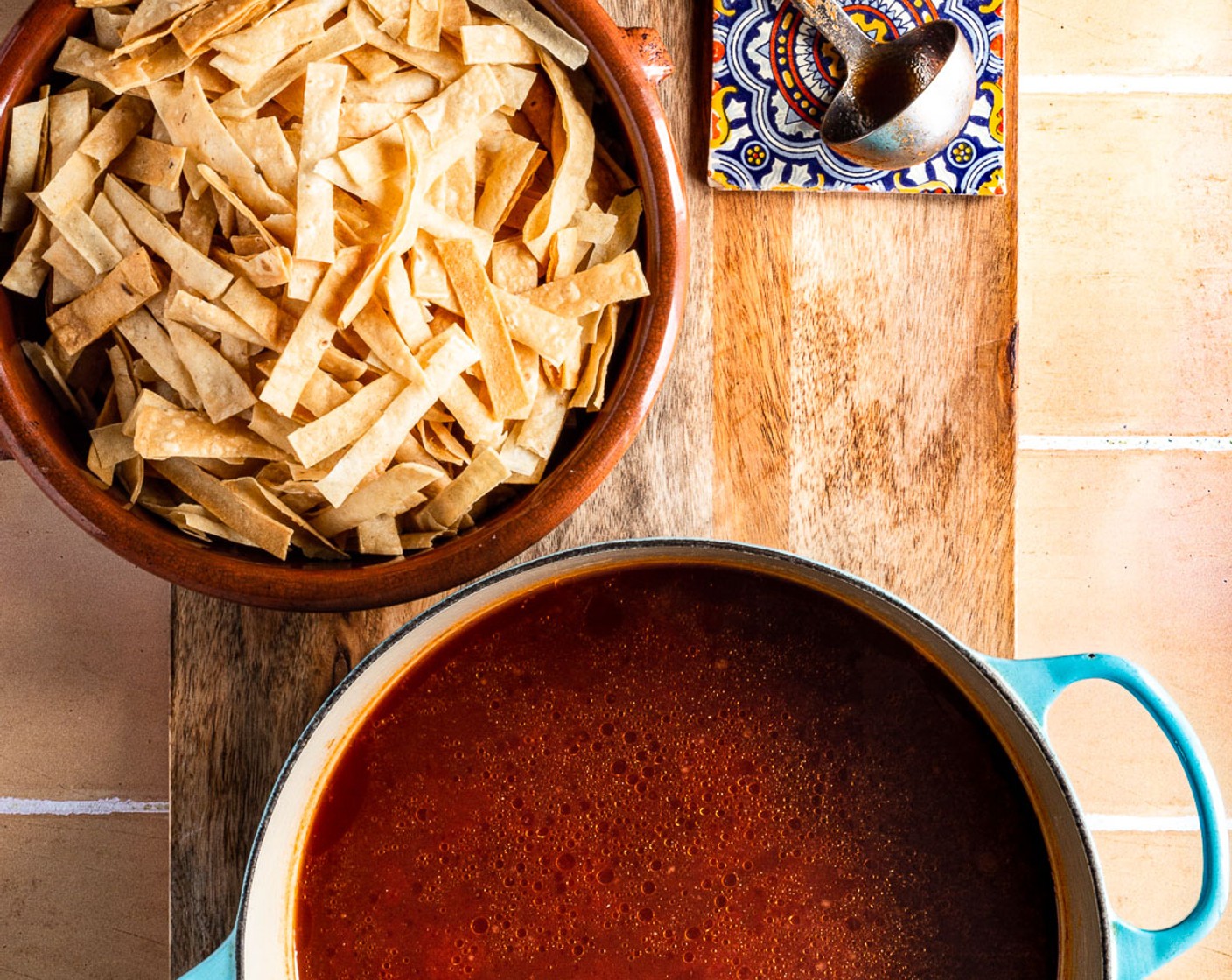 step 9 On high heat in a deep pot, combine 4 cups of chicken broth along with the tomato chile sauce, and an additional 2 cups of water. Let this boil for 15-20 minutes. Season with Salt (to taste) and Ground Black Pepper (to taste).