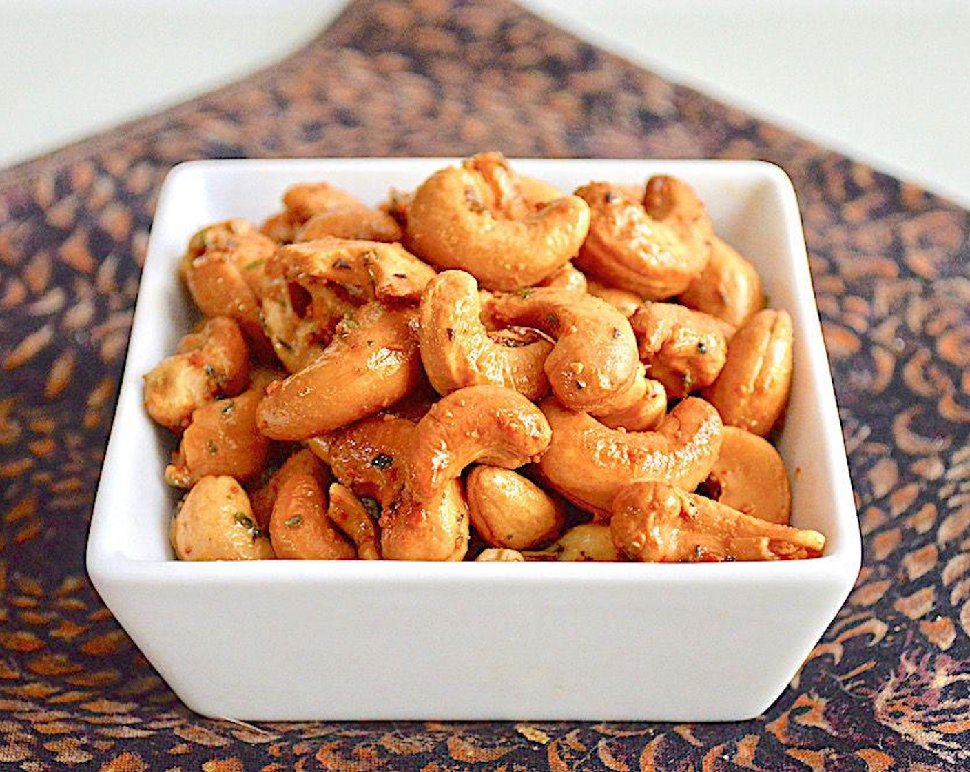 step 3 Spread the coated cashews out in a single layer on the sheet tray and roast them for about 10 minutes. Serve them immediately for a yummy snack!