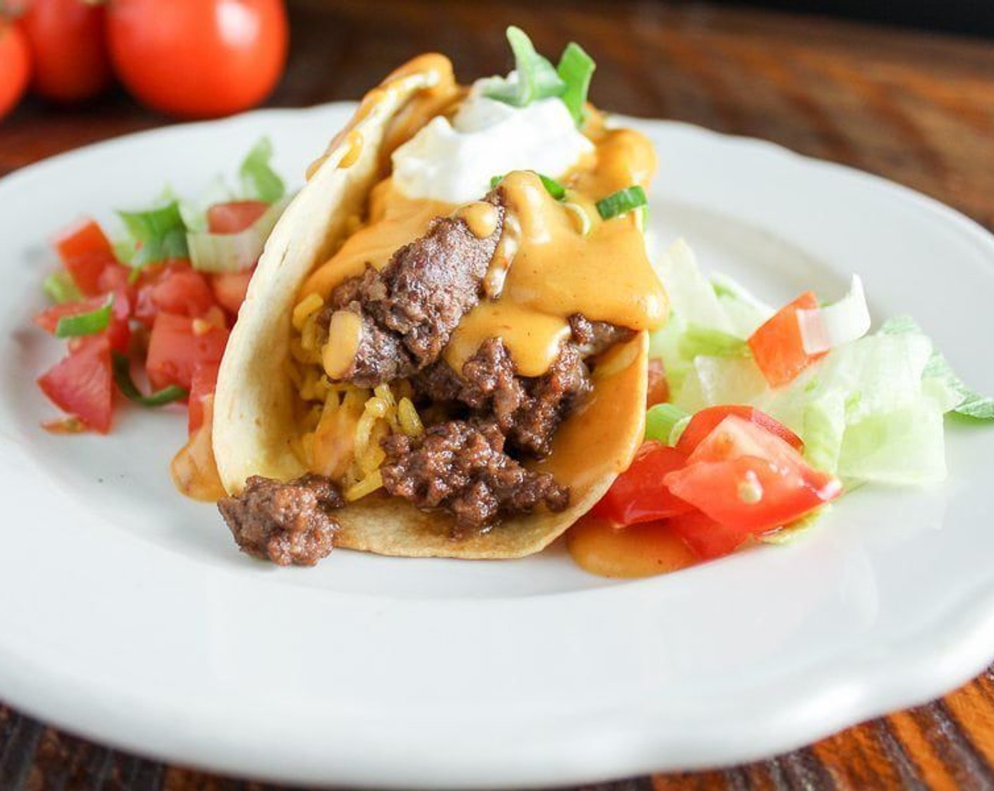 step 11 Serve the tacos warm with the Chipotle Cheesy Sauce, Lettuce (to taste), Tomatoes (to taste), Scallions (to taste), and Sour Cream (to taste). Enjoy!