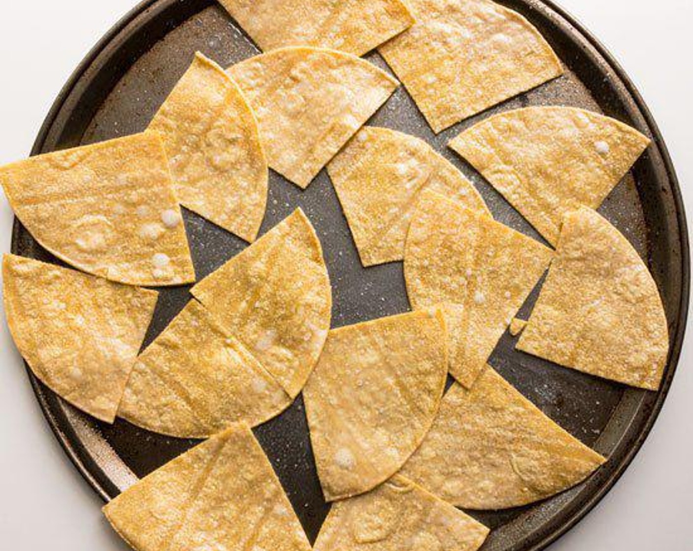 step 3 Spray Yellow Corn Tortilla (1 pckg) with Canola Oil Spray (as needed) on both sides and sprinkle with a little Salt (to taste). Stack tortillas and slice into 4's with a pizza wheel.