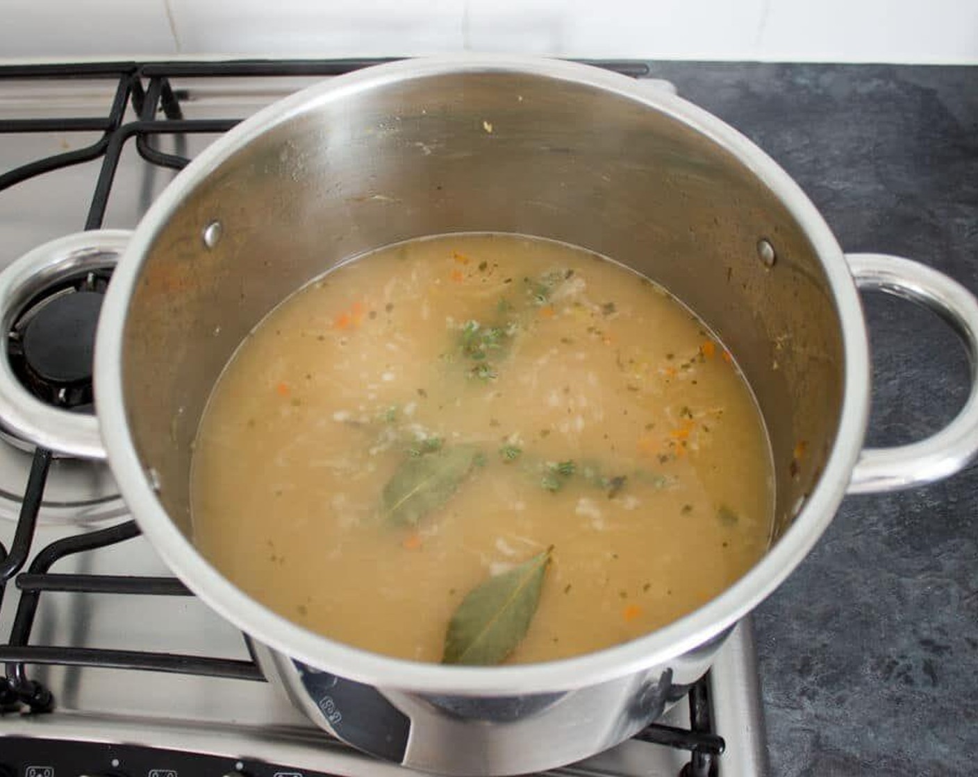 step 5 Gradually add in the Chicken Stock (8 1/3 cups) then bring it all to a boil. Add in the Bay Leaves (2), Fresh Thyme Leaves (2 sprigs), and a generous helping of Salt (to taste) and Ground Black Pepper (to taste). Stir it all up, pop the lid on and simmer for about 25 minutes.