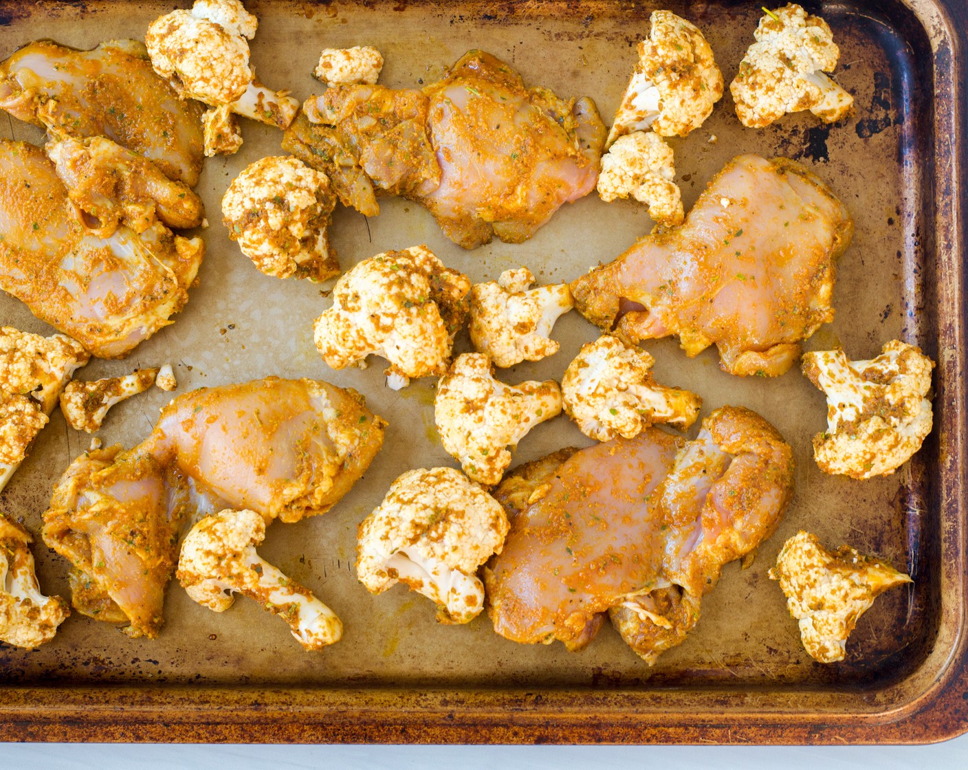 step 4 Arrange the cauliflower and chicken on a sheet pan (or two sheet pans if necessary to avoid crowding) and place in the preheated oven. Bake until the internal temperature of the chicken reaches 160 degrees F (71 degrees C), about 20 minutes.