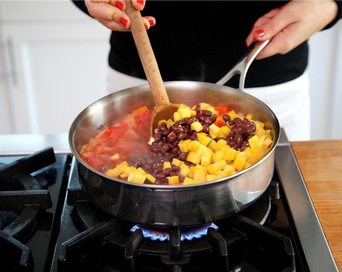 step 6 Stir in the Black Beans (1 can) and continue to simmer gently for 5 minutes.