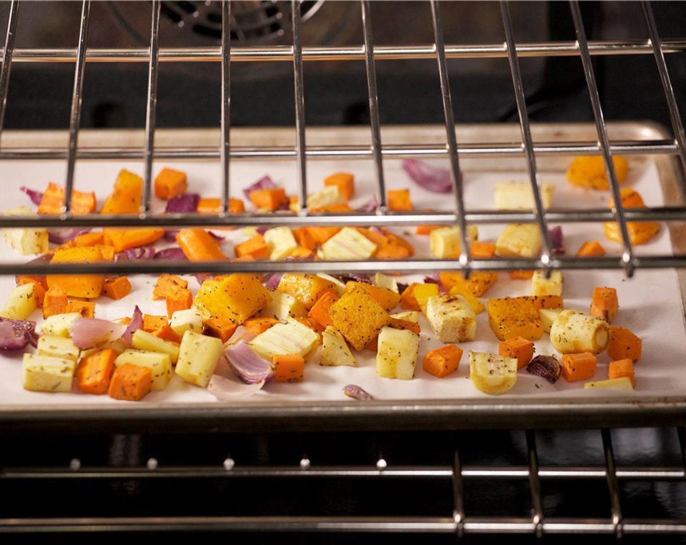 step 9 Place the vegetables on a sheet pan lined with parchment paper and roast in the oven for 18 minutes, or until tender.