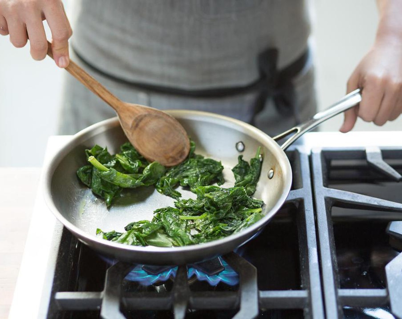 step 6 Heat a medium sauté pan over high heat and Olive Oil (1 Tbsp). When the oil is hot, add the Fresh Baby Spinach (3 3/4 cups) and season with Salt (to taste) and Ground Black Pepper (to taste). Saute for 30 seconds until the spinach is slightly wilted. Remove from heat and transfer to a plate.