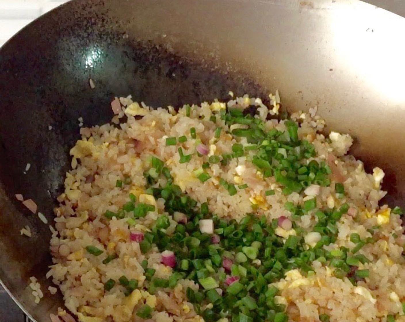 step 16 Lastly, add in the chopped scallions. Continue to stir fry until well combined.