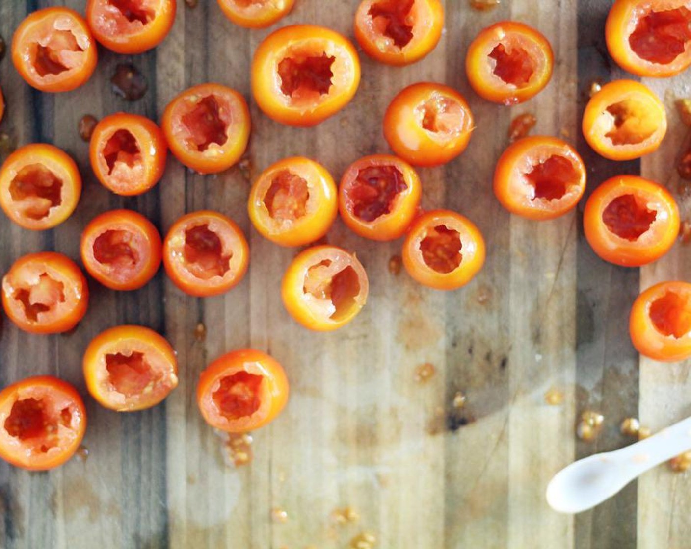 step 4 Using a tomato scoop or small spoon, carefully scoop out the tomato pulp and seeds. Discard.