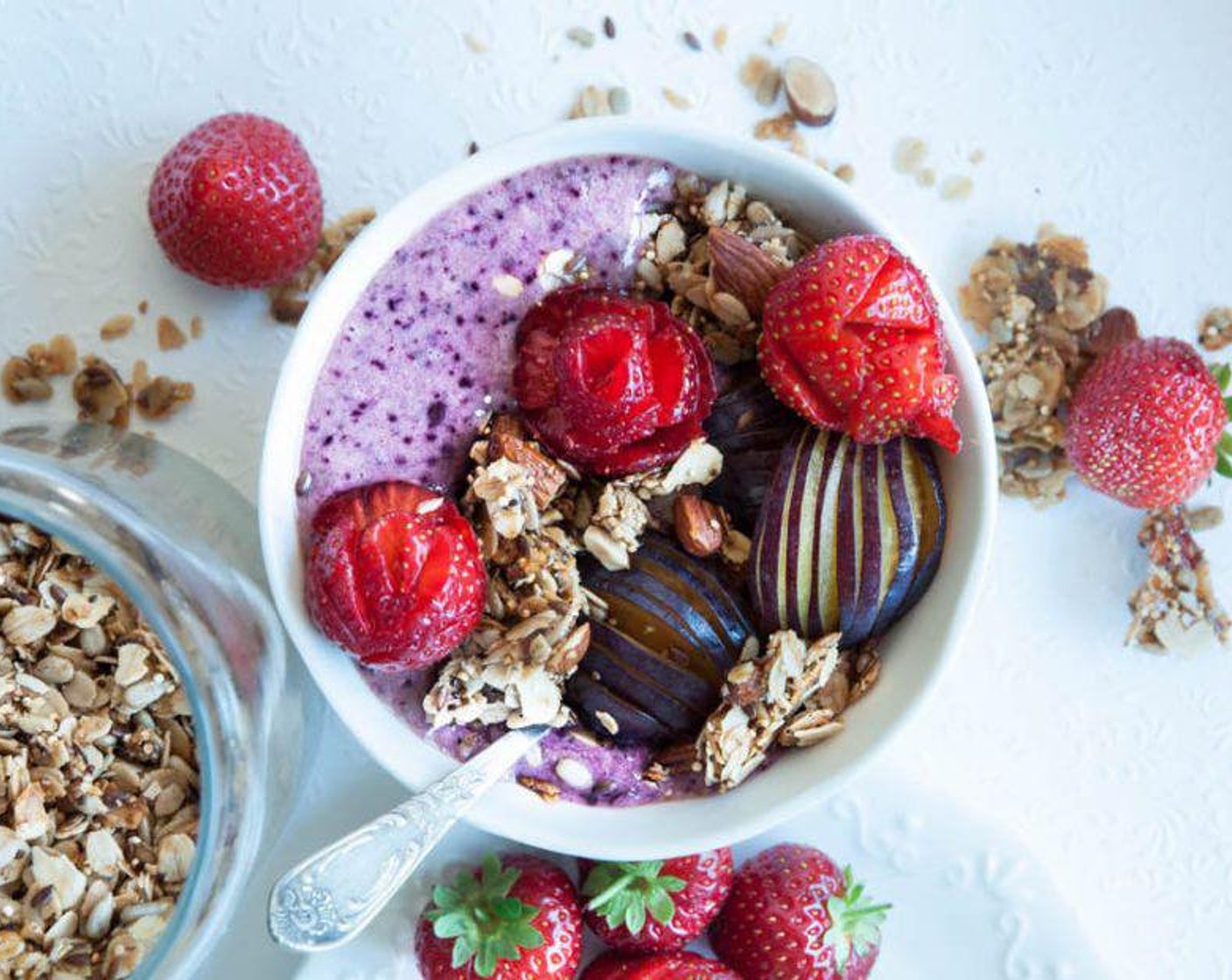 step 2 Decorate with Honey Granola (1 handful), Plums (2), and Fresh Strawberries (to taste). Serve and enjoy!