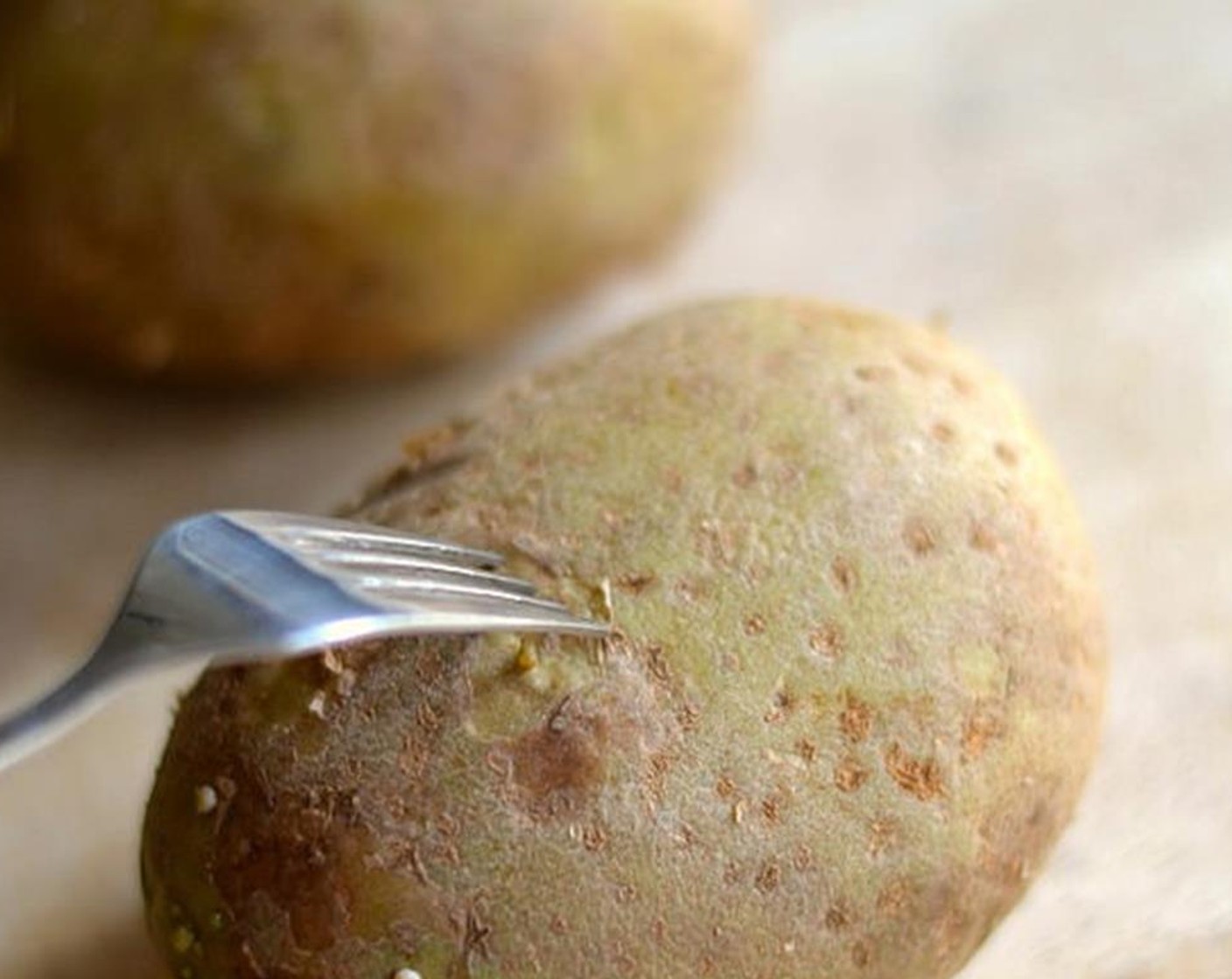 step 1 Scrub the Potatoes (2) and stab them several times with a fork. That’s for steam to escape, otherwise you risk a potato explosion in your oven.