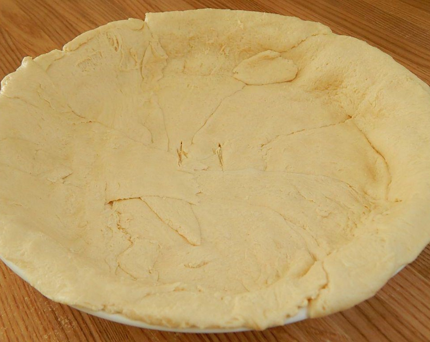 step 2 Spray an 8-inch pie dish. Unroll the Pillsbury™ Reduced Fat Crescent Rolls (1 pckg) and use the pieces to shape a pie crust into your dish. This will require a little work and you might need to break some pieces and even things out.