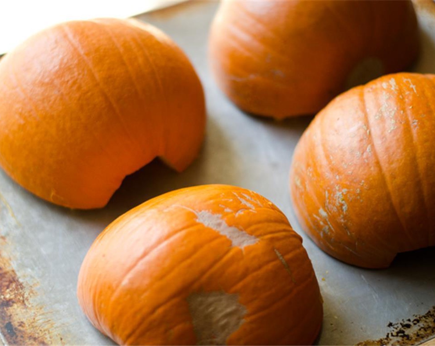 step 2 Chop the tops off the Sugar Pumpkins (2), cut them in half lengthwise, and scoop out the seeds/stringy bits with a spoon. Rub Olive Oil (2 Tbsp) on the inside of each, then place face down on a baking sheet and roast for about 1 hour at 350 degrees F or until fork tender.