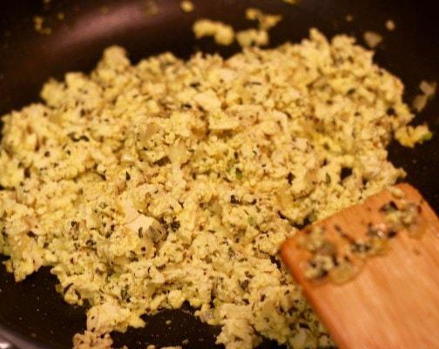 step 2 Take the Firm Tofu (14 oz) and squeeze it through your hands so it crumbles into the pan. Add Fresh Oregano (to taste), Fresh Basil (to taste), and a pinch of Salt (to taste) and Ground Black Pepper (to taste), Cook and occasionally stir for about 3-5 minutes.