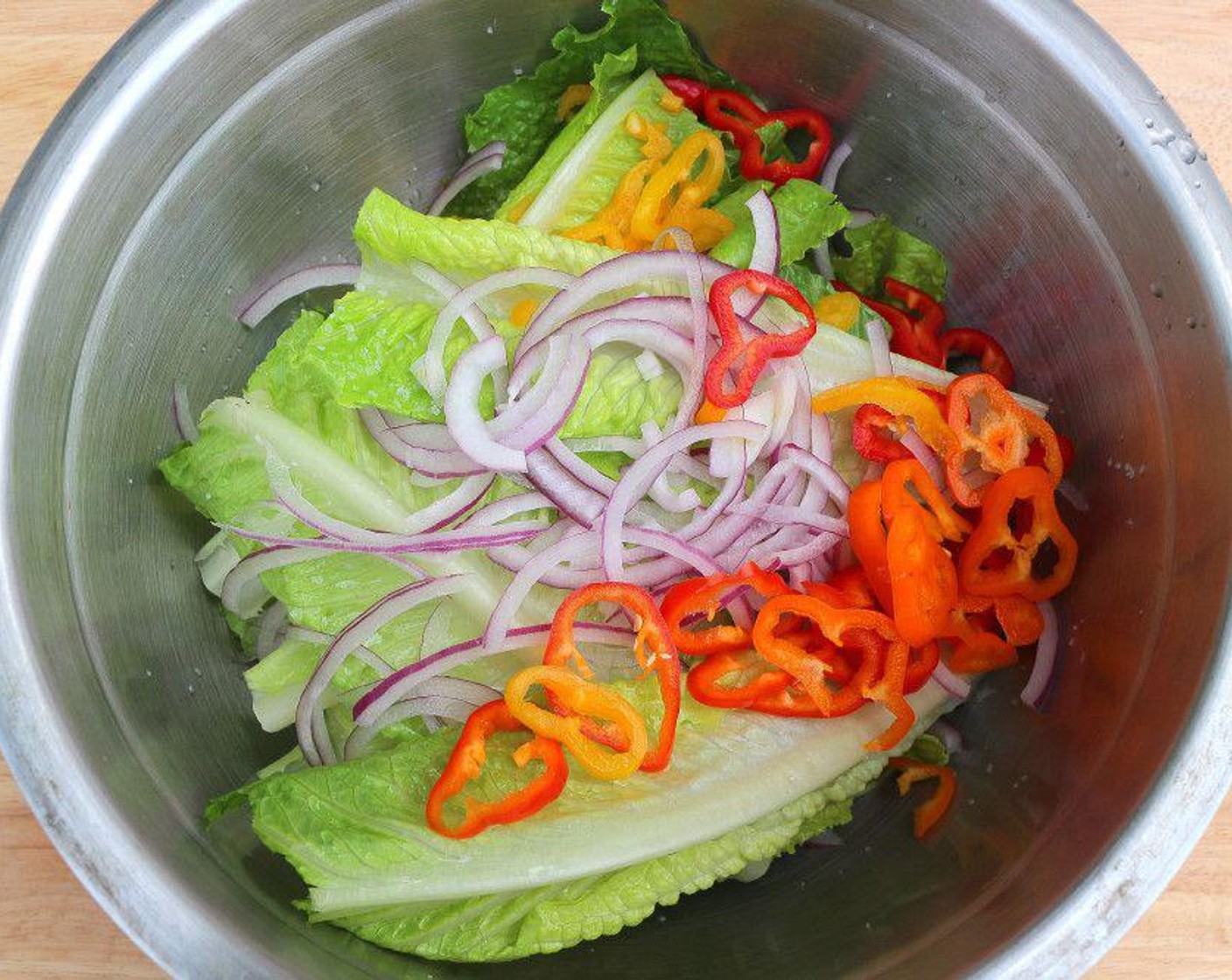 step 1 Dress Romaine Lettuce (to taste) leaves, Chili Peppers (to taste) and Red Onions (to taste) in a Vinaigrette (to taste) of your choice.