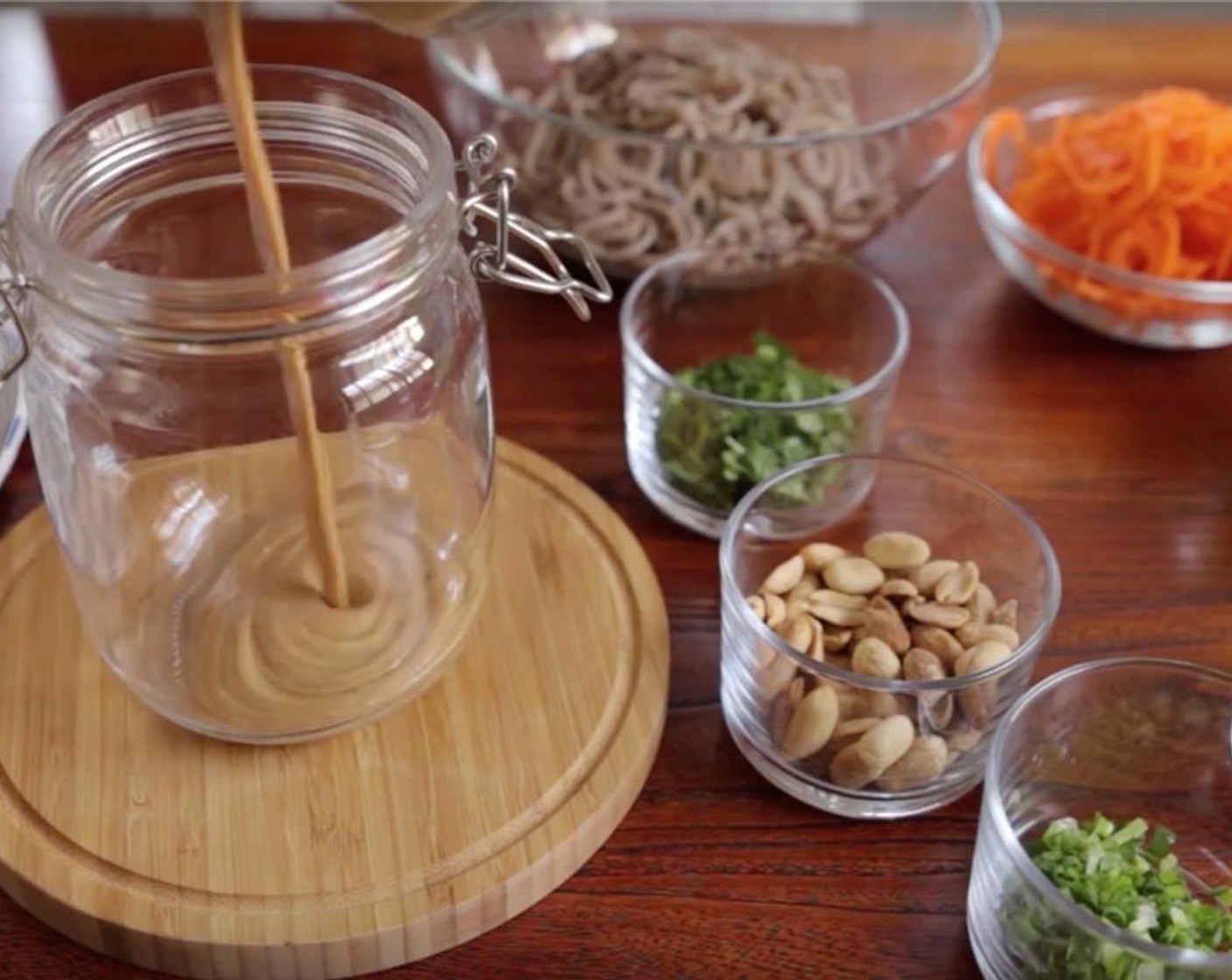 step 9 To assemble each jar, divide all the ingredients into 4 portions and in each jar, layer the ingredients as follows: Peanut Sauce.