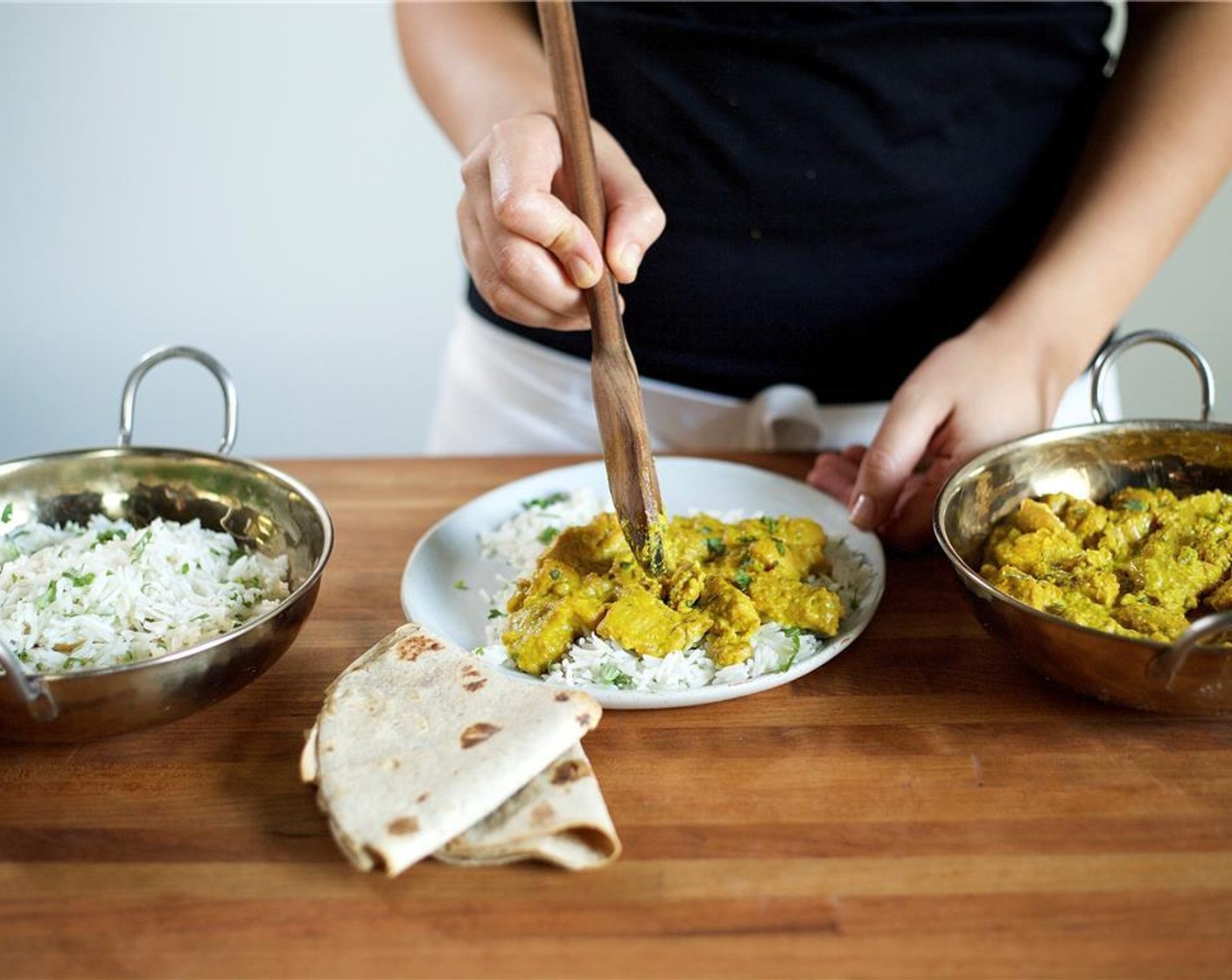 step 13 In the center of two plates, scoop cilantro rice and top with chicken. Garnish with chopped cilantro and squeeze fresh Lime (1) juice evenly over each dish. Serve naan bread on the side.