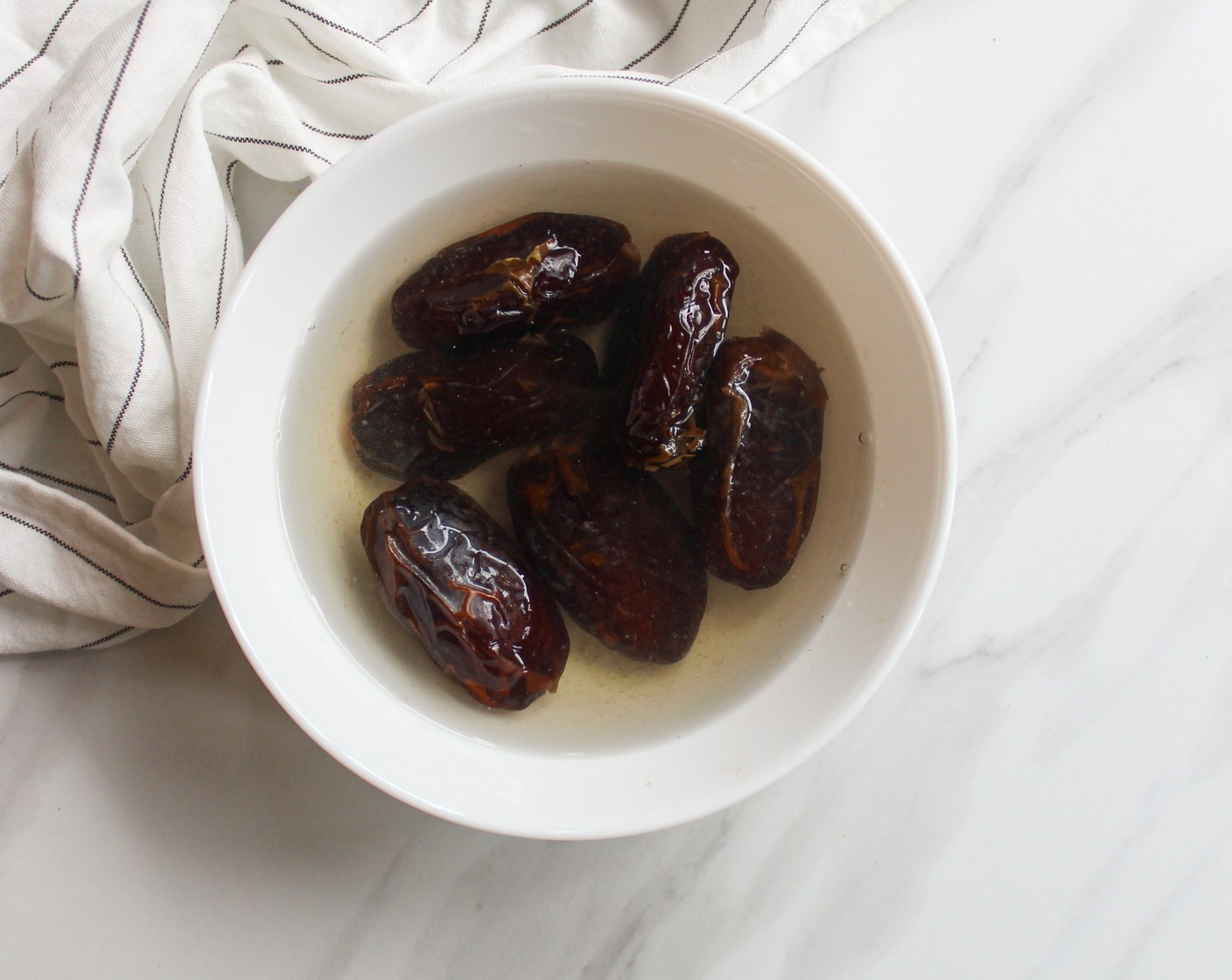 step 1 Start by soaking your Dates (1 cup) in hot water for at least 20 minutes to soften them. Pit them and set aside.