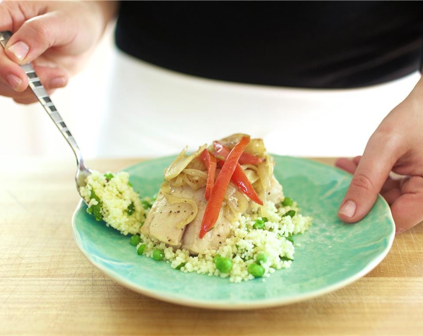 step 13 Divide the couscous between two plates. Lay a piece of snapper over the couscous, centered. Top the fish with the fennel, onion, and tomato mixture.