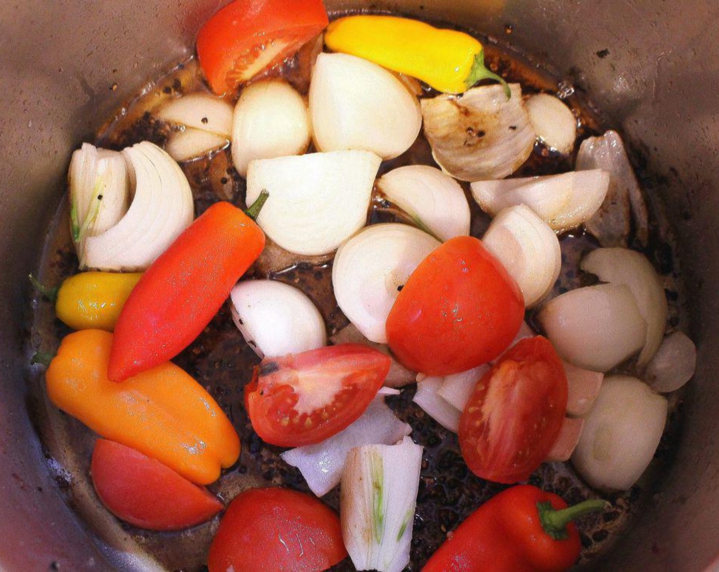 step 3 In the remaining fat, sauté Onions (2), Tomatoes (2), Chili Peppers (5), and Garlic (5 cloves) until the onions are caramelized.