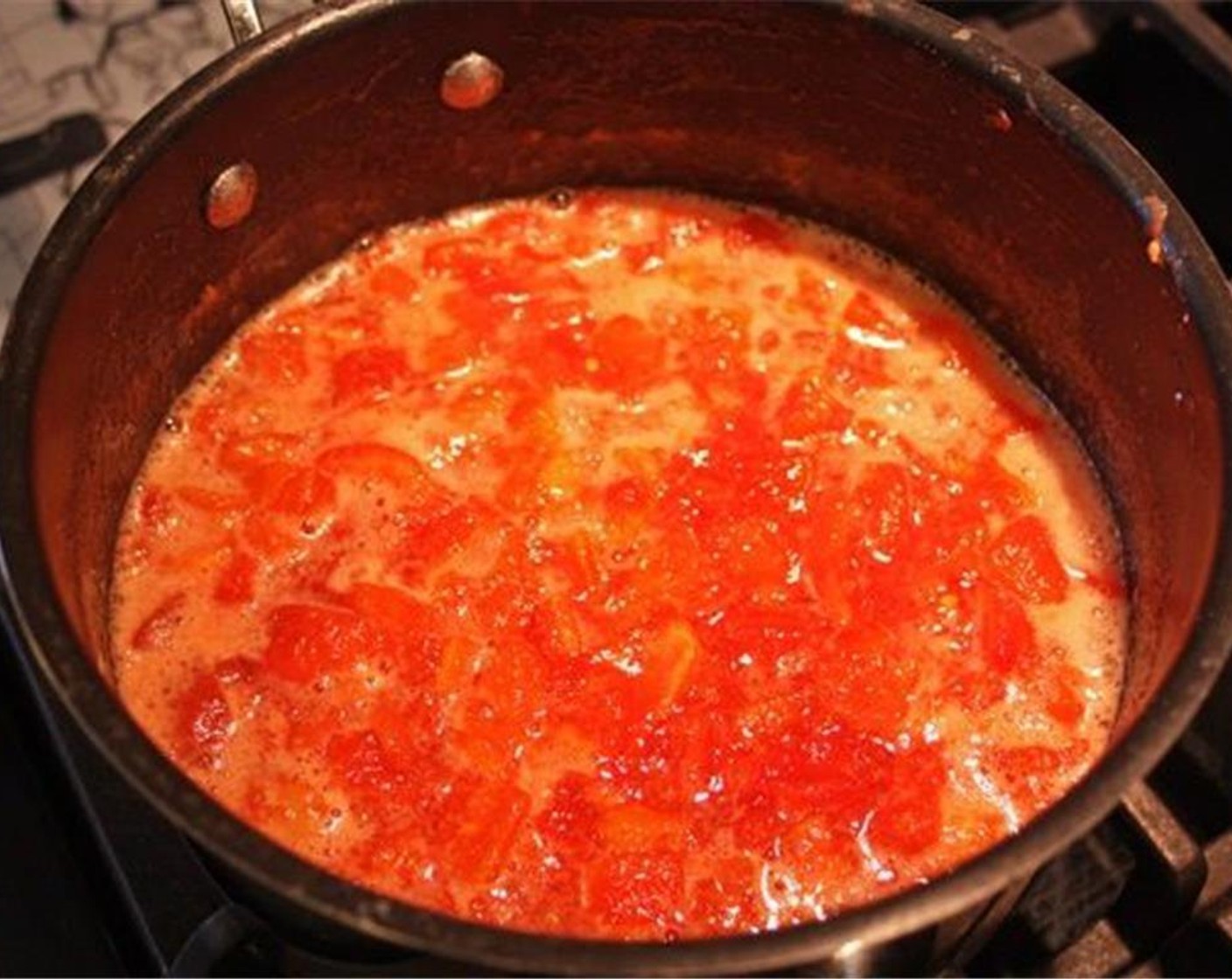 step 7 Roughly chop the tomatoes and put them into a pot along with Granulated Sugar (1 cup), the juice from Lemons (1 1/4) and Cinnamon Stick (1). Bring to a boil for a few minutes. Then reduce heat to medium-low.