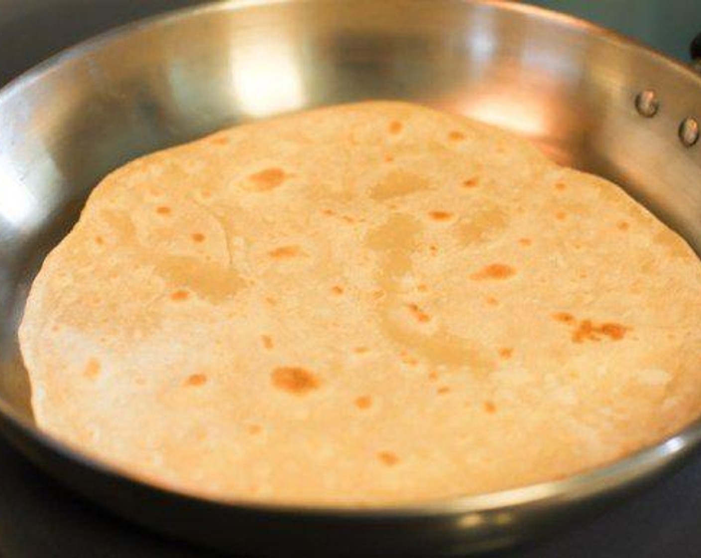 step 6 Preheat pan to medium to medium-high heat. Place a tortilla in the heated pan until golden brown on one side (about sixty to ninety seconds). Flip tortilla on other side to brown. Remove tortilla and place on a plate or in a container. Repeat for remaining tortillas.