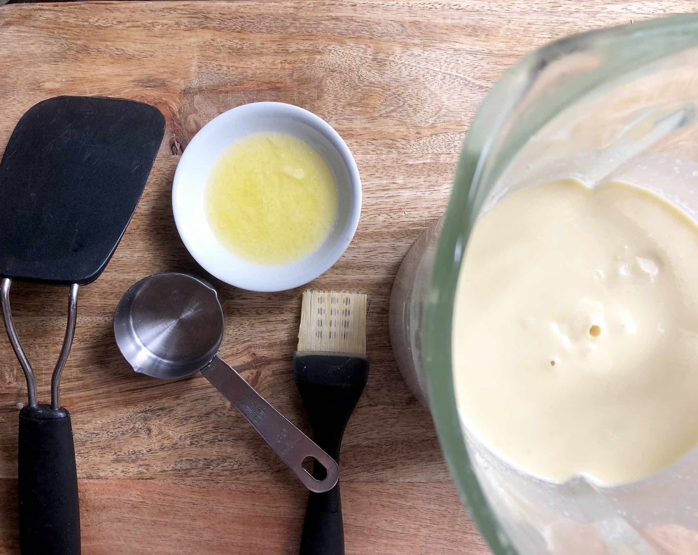 step 4 Put a non-stick pan over medium heat. Have handy a thin wide spatula, a pastry brush, a 1/4-cup measure and a dinner plate for the cooked crepes.