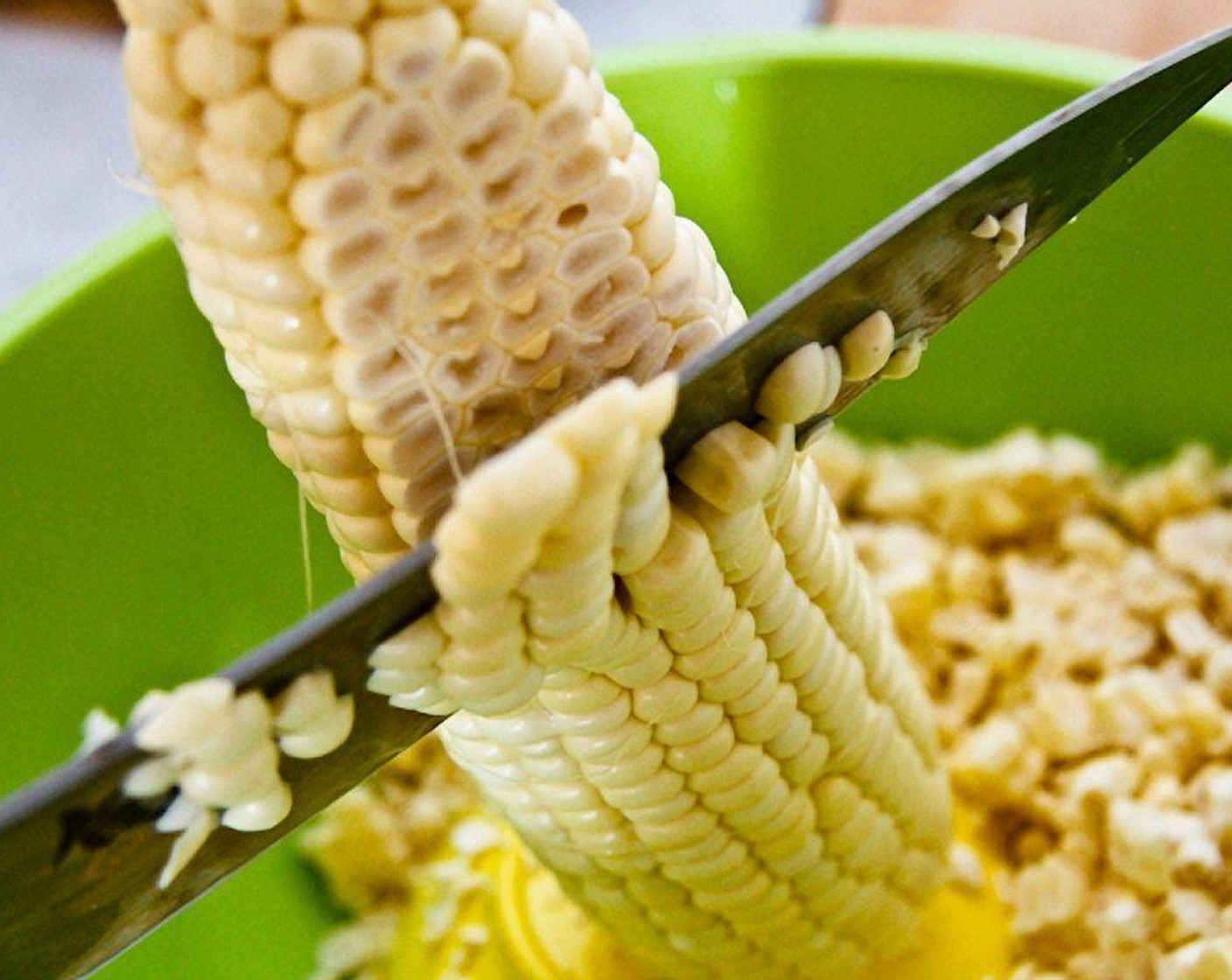 step 4 After the kernels are sliced away, gently scrape the cobs with your knife to catch some of the corn "milk."
