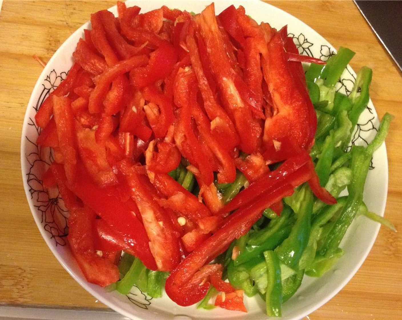 step 2 Slice the Green Bell Peppers (2) and Red Bell Peppers (2) into strips.