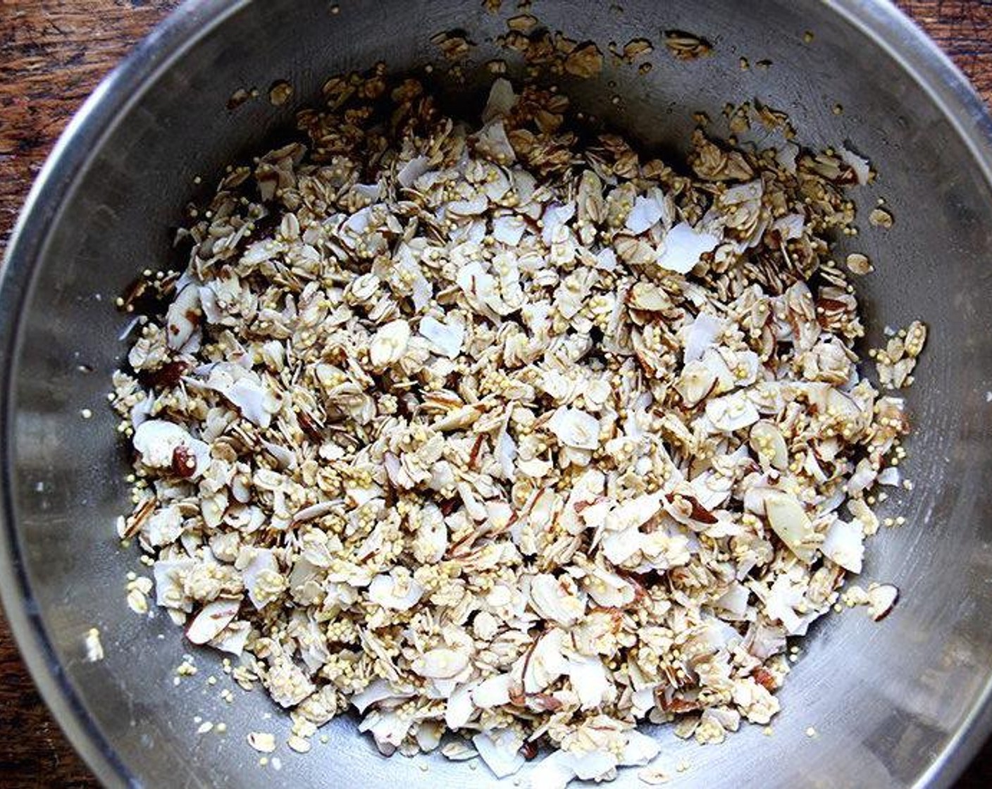 step 2 In a large bowl, toss together the Whole Millet (1/2 cup), Old Fashioned Rolled Oats (2 cups), Unsweetened Coconut Flakes (3/4 cup), Sliced Almonds (1 1/4 cups) and Sea Salt (1 tsp). Pour in the Maple Syrup (1/2 cup) and Coconut Oil (3 Tbsp). Stir to coat.