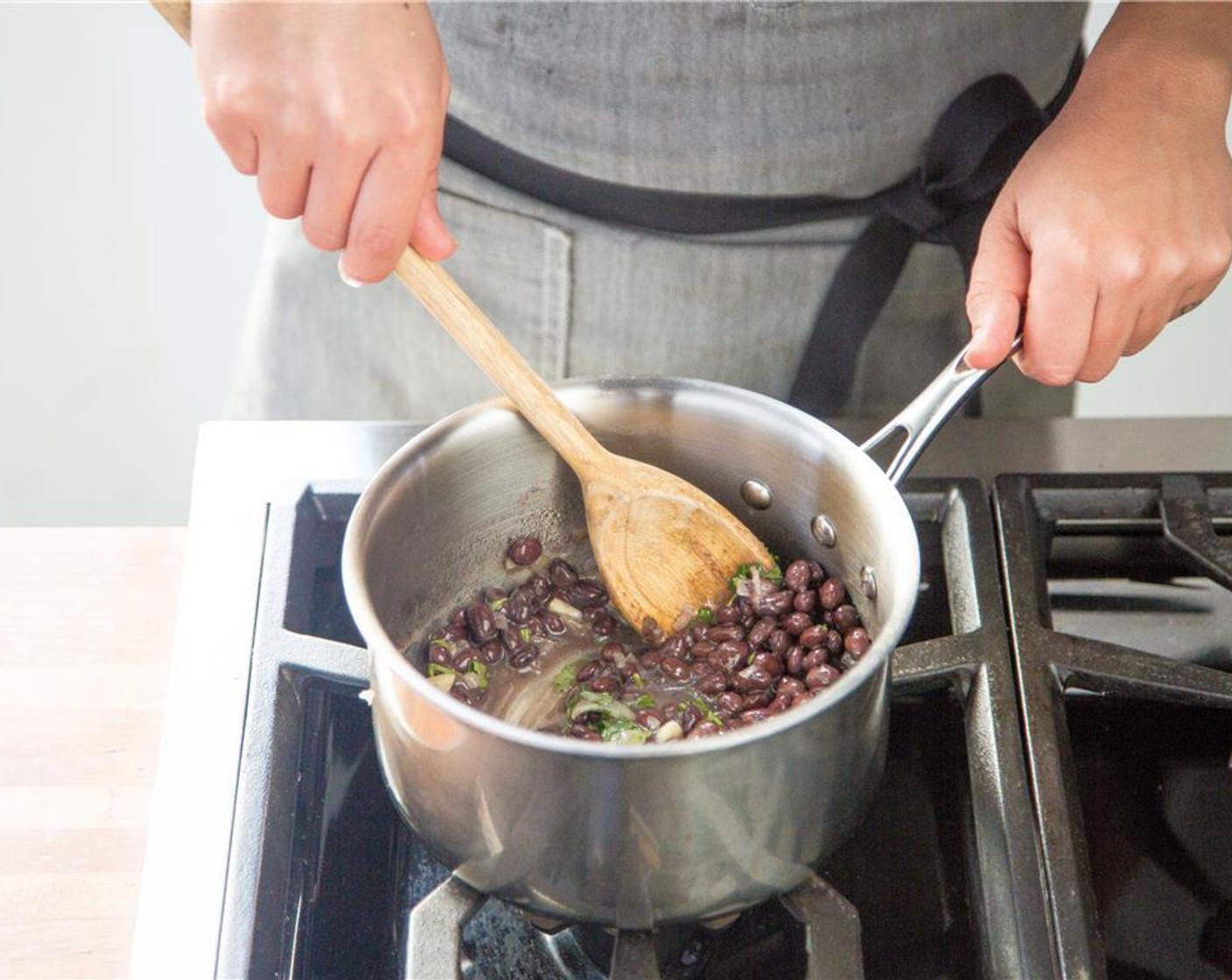 step 15 Once heated through, remove from heat, stir in half of the remaining cilantro, and keep warm for plating.