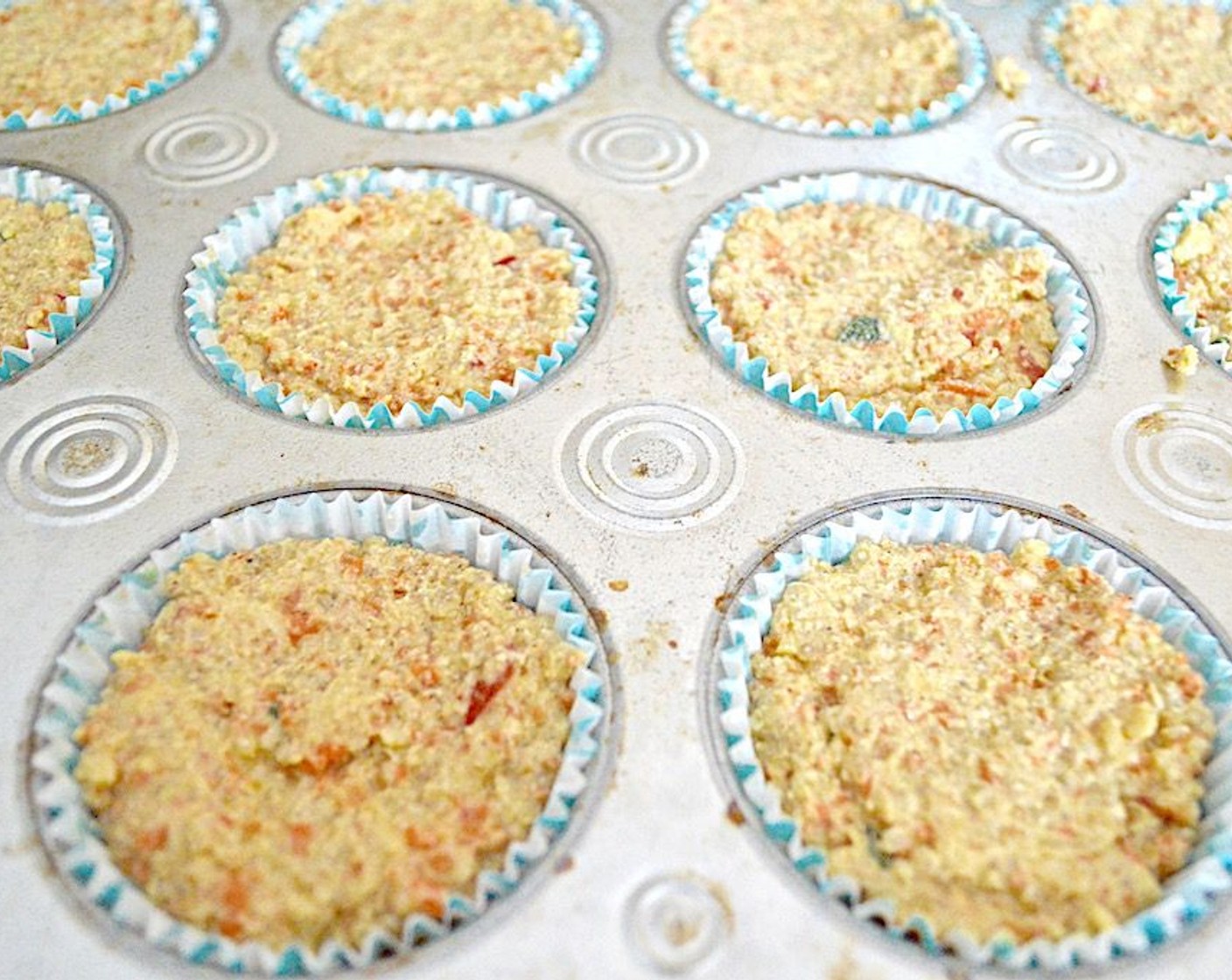 step 7 Fill each lined muffin well to the top using a heaping 1/4 cup as an approximation. Gently press the batter firmly into each liner so that it is solid and even.