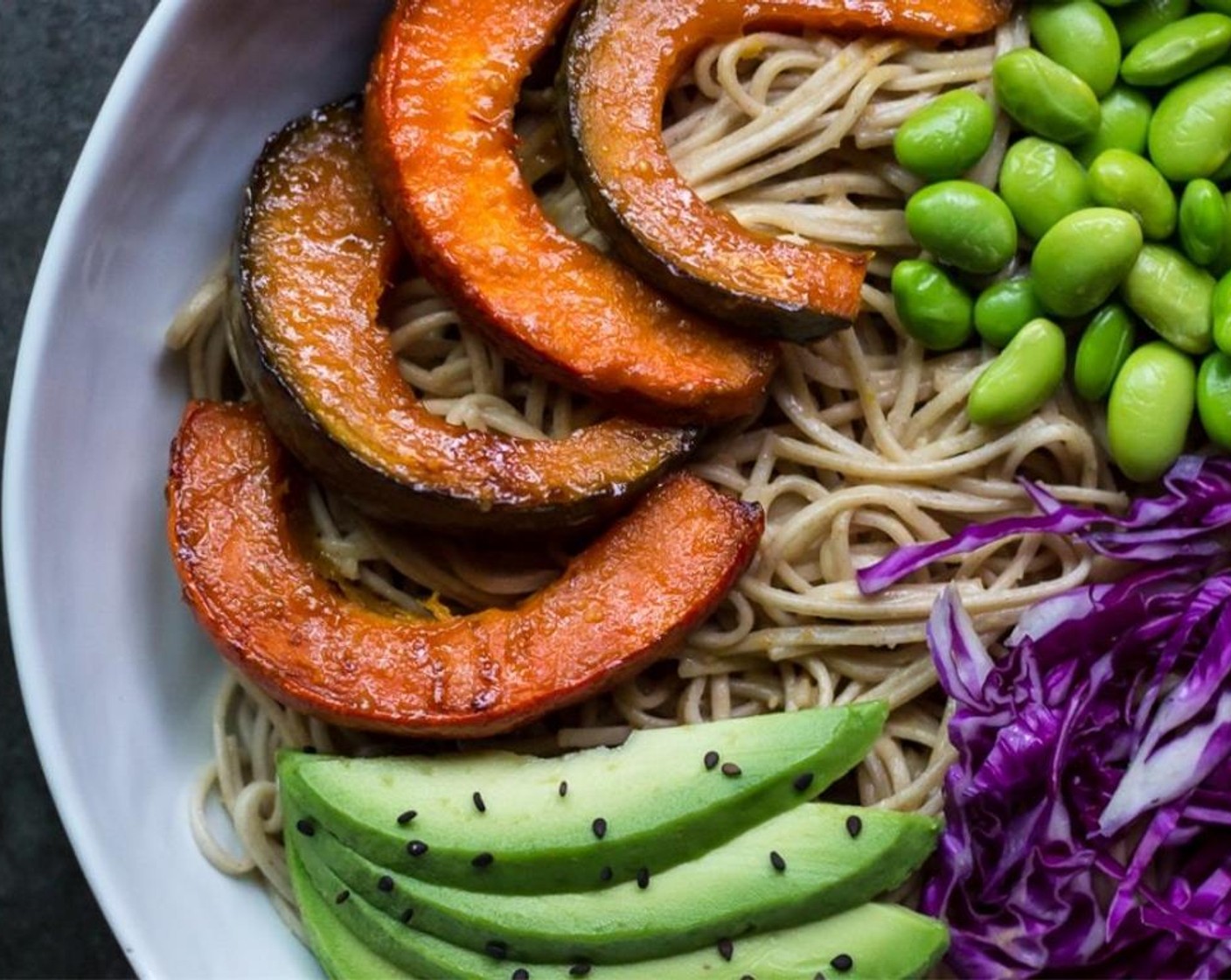 step 9 Top each bowl with slices of roasted kabocha, Avocado (1), Red Cabbage (1 cup), and Edamame (1 cup). Sprinkle Black Sesame Seeds (to taste) and enjoy!