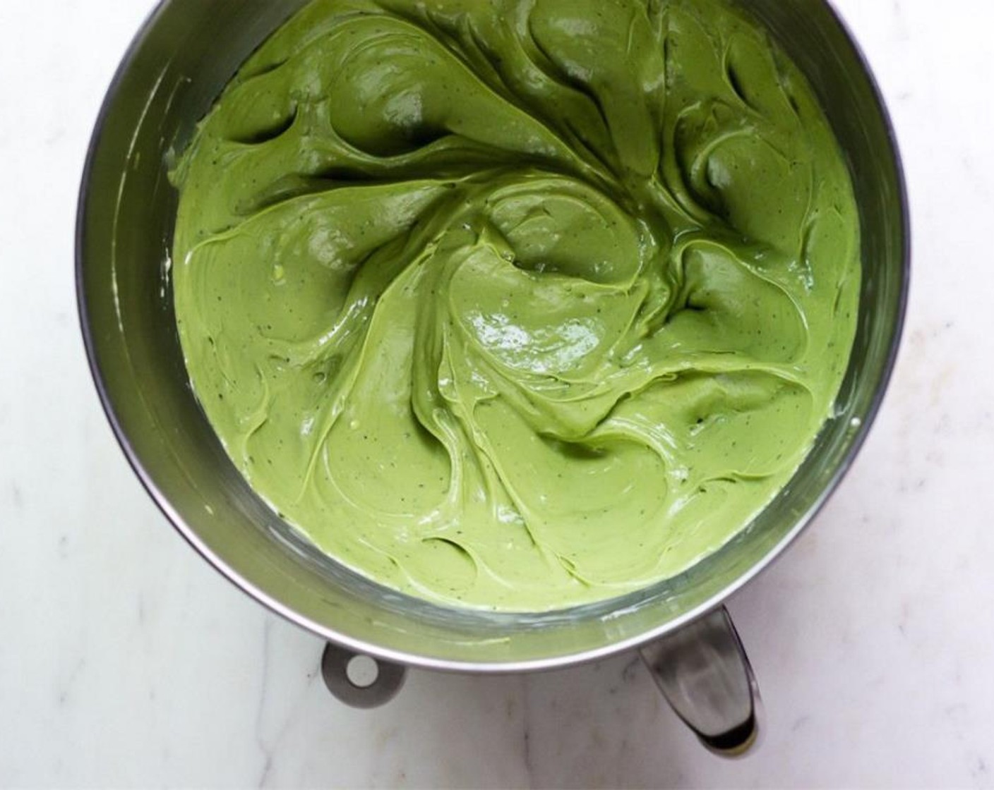 step 6 Portion about 3/4 of brownie batter into the prepared pan. Add the matcha cheesecake to the top of the brownie batter in an even layer.