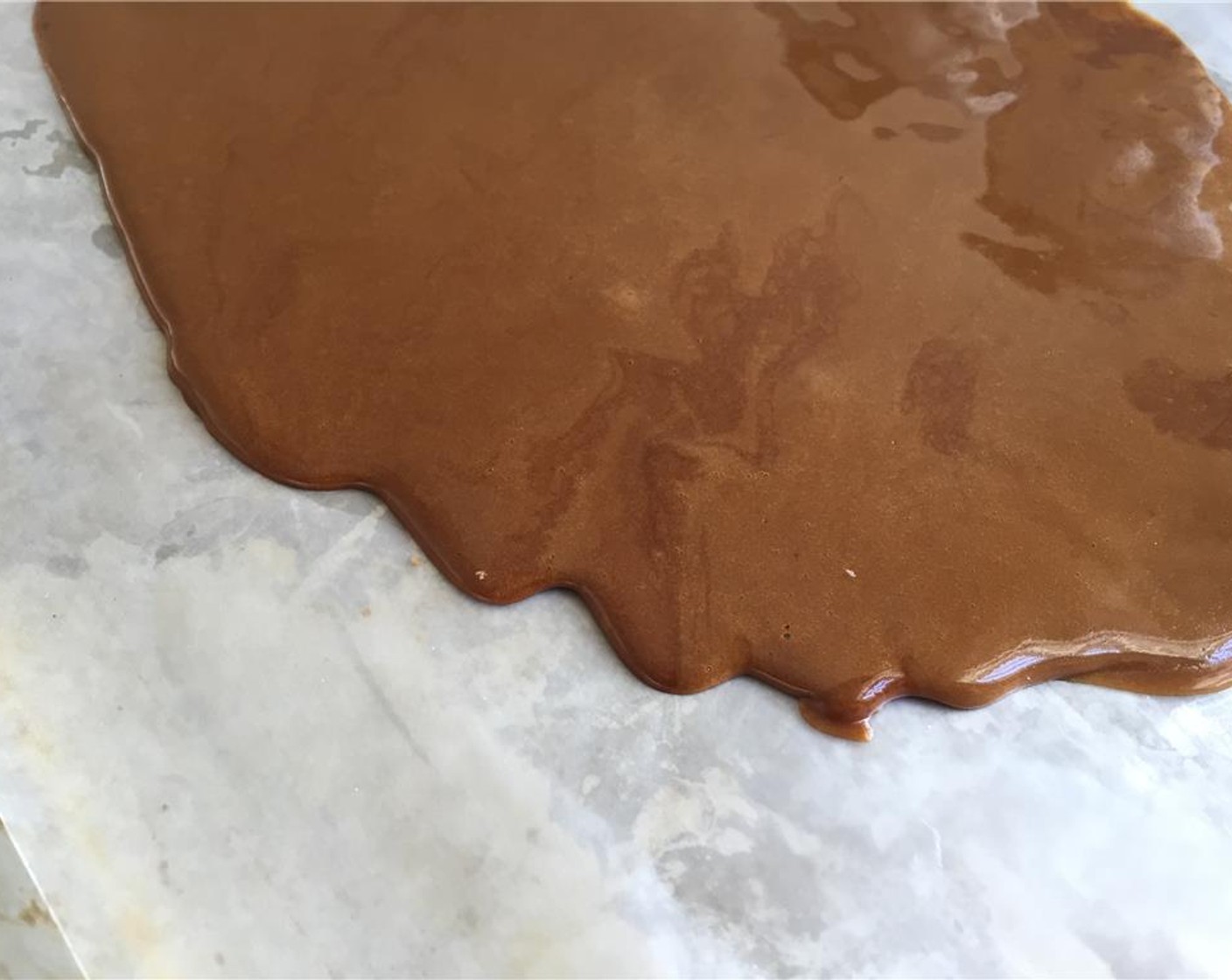 step 3 Pour the melted sugar onto a parchment lined baking sheet and allow it to cool completely, about 15 minutes.