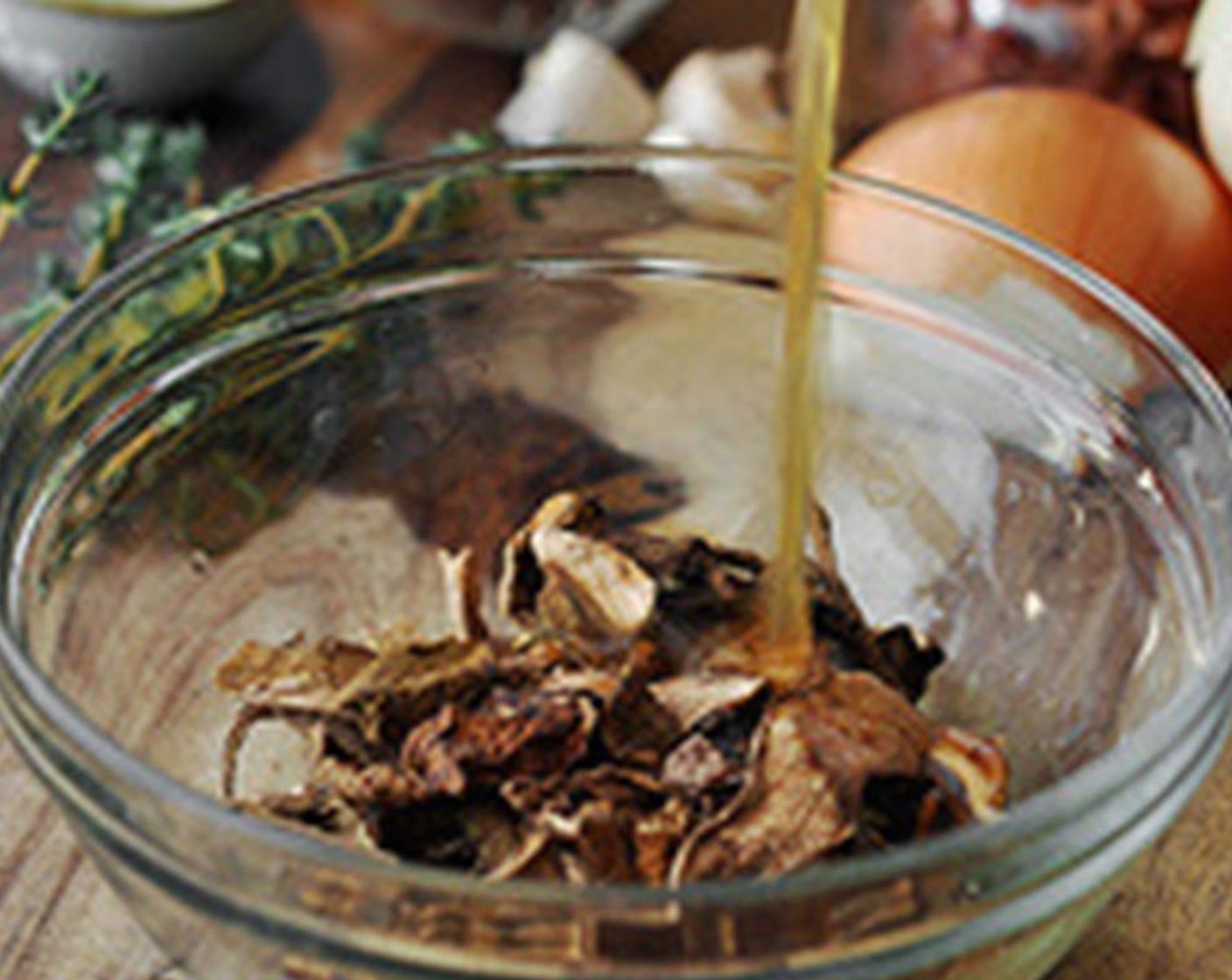 step 2 Place the Dried Mushrooms (1 pckg) into a small bowl and cover with the Chicken Stock (1/2 cup). Cover with plastic wrap and allow to re-hydrate.