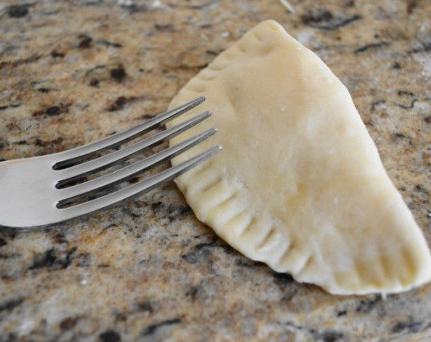 step 7 Fill each of the circles with two tablespoons of filling on one half, then bring the other half over to enclose it and pinch it together thoroughly. Really seal them even more and make a pretty pattern along the edge by pressing down with the tines of a fork over the whole edge.