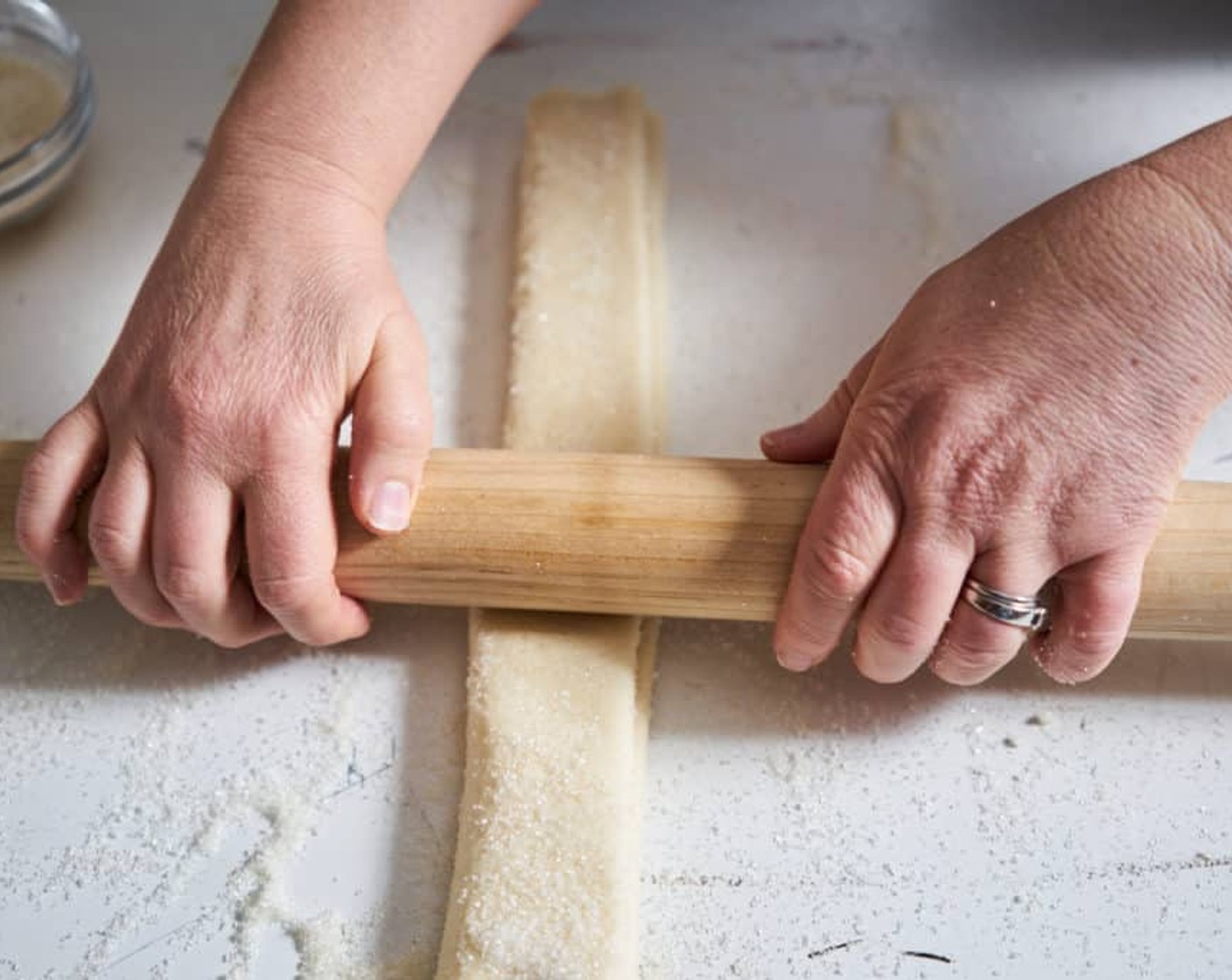 step 5 Fold the rectangle in half one more time, and gently roll down the strip of dough so that it is pressed together and holds its shape. Again, you do not want to make the dough thinner, you are just ensuring it stays folded. Place in the fridge for 30 minutes to chill on a parchment-lined baking sheet.