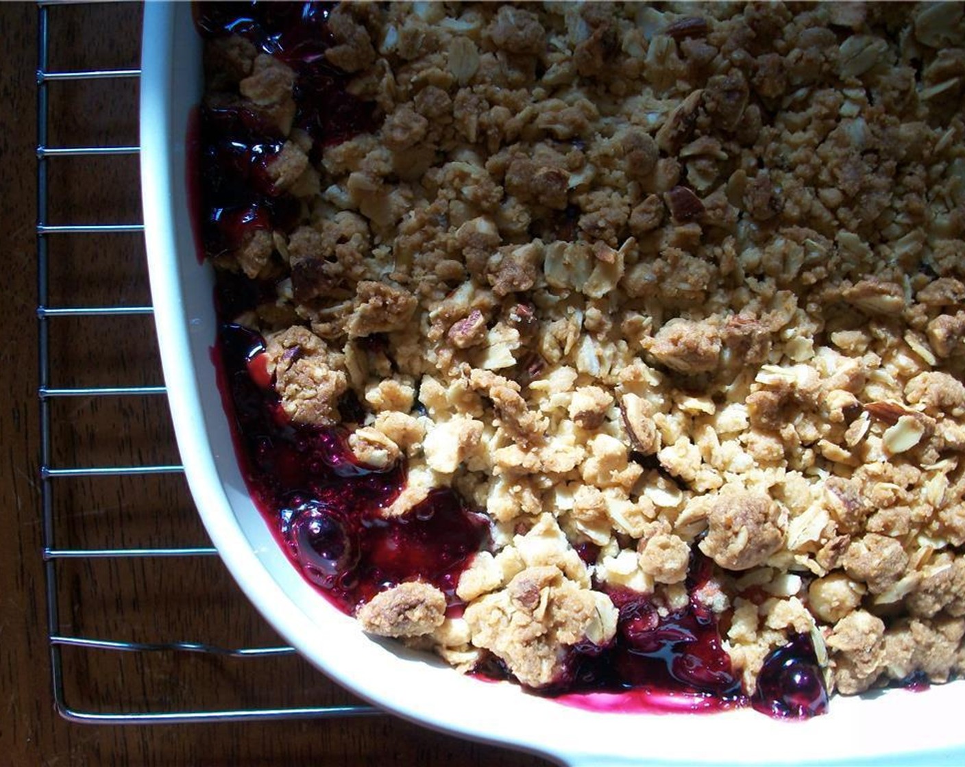 step 5 Lightly grease an 8 inch baking pan and put the berry-mixture in. Top with the oat-mixture.