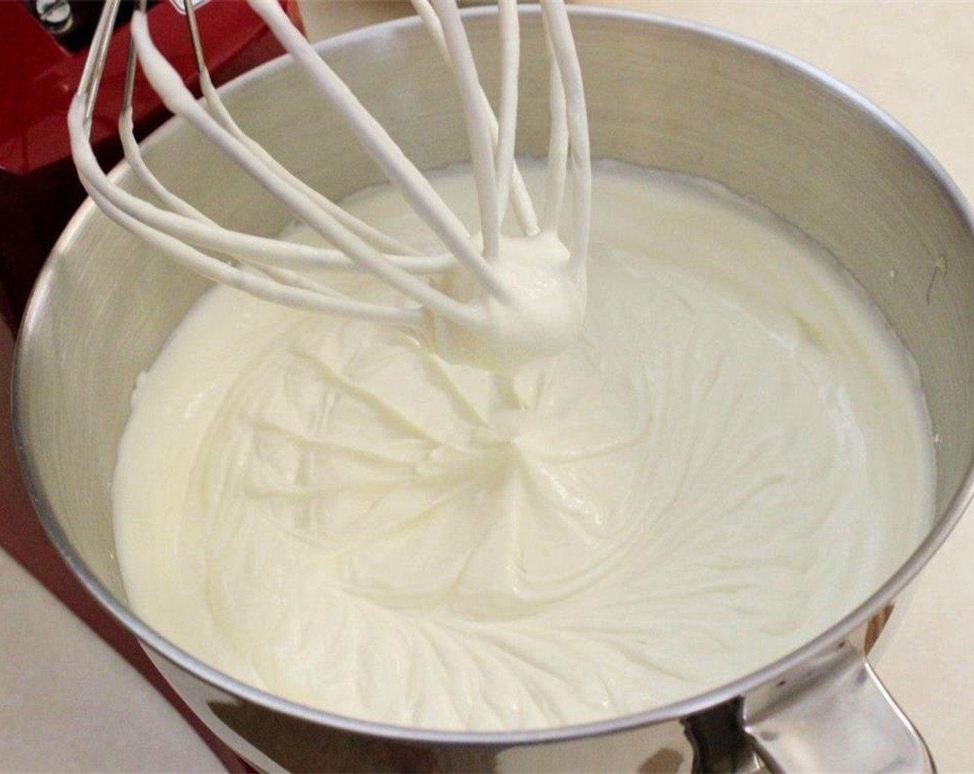 step 7 Combine the Sour Cream (1/4 cup), La Lechera® Sweetened Condensed Milk (1 can), Powdered Confectioners Sugar (1/2 cup), and Vanilla Extract (1/2 Tbsp) in a standing mixer using the whisk attachment. Add the heavy Heavy Cream (1 cup) and continue whisking until frosting thickens.