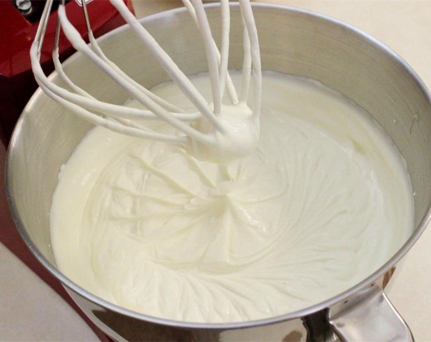 step 7 Combine the Sour Cream (1/4 cup), Sweetened Condensed Milk (1 can), Powdered Confectioners Sugar (1/2 cup), and Vanilla Extract (1/2 Tbsp) in a standing mixer using the whisk attachment. Add the heavy Heavy Cream (1 cup) and continue whisking until frosting thickens.